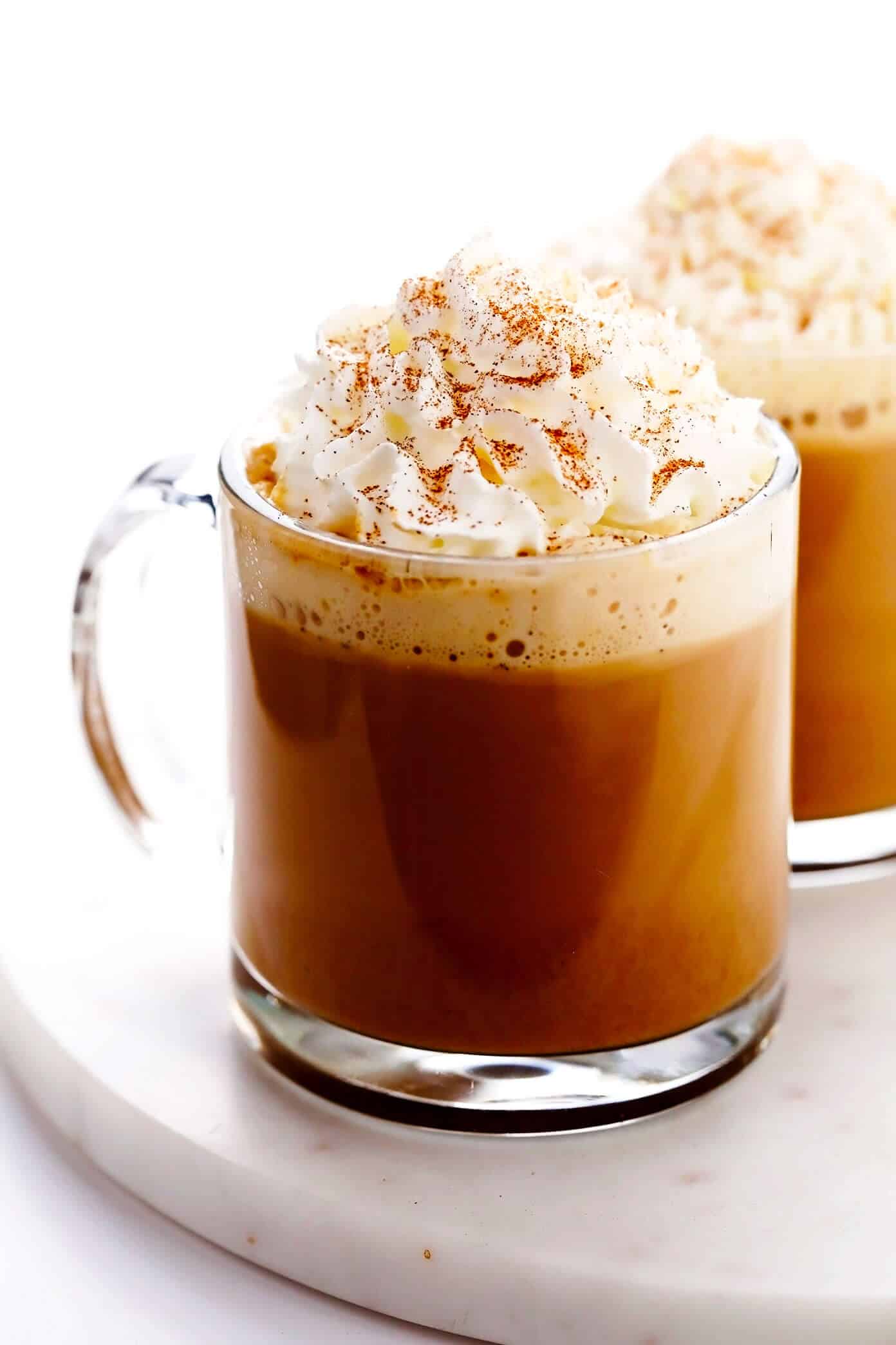 This homemade pumpkin spice latte recipe is inspired by the Starbucks version, yet lightened up a bit and naturally sweetened with maple syrup. Feel free to use your favorite kind of milk and make your drink with either espresso or very strongly brewed coffee. | gimmesomeoven.com Homemade Pumpkin Spice Latte with Whipped Cream and Pumpkin Pie Spice