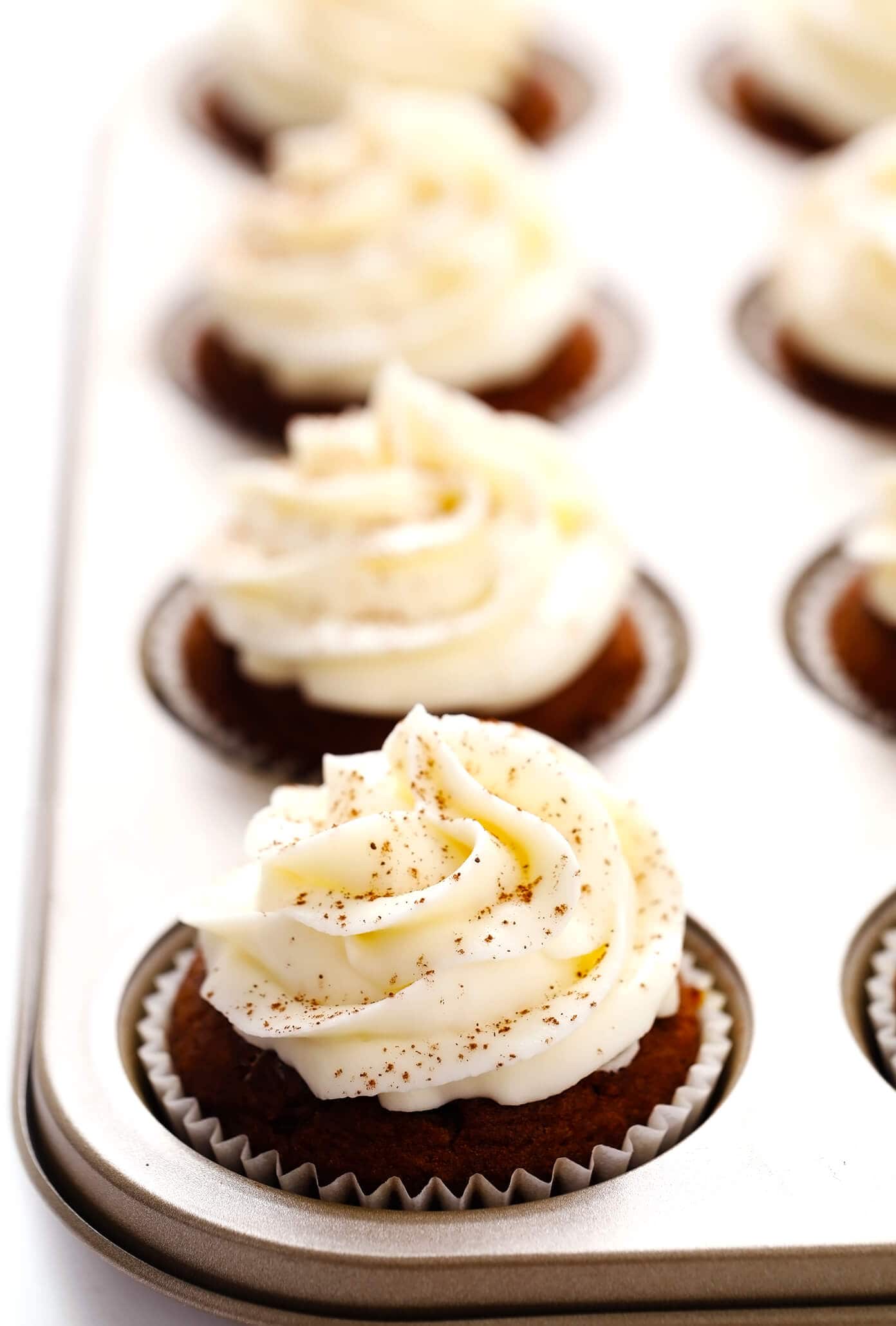 These pumpkin cupcakes are quick and easy to make, perfectly moist and fluffy and flavorful, and topped with the most heavenly cream cheese frosting. | gimmesomeoven.com #pumpkin #cupcakes #cake #creamcheese #frosting #icing #thanksgiving #halloween #fall #dessert Pumpkin Cupcakes with Cream Cheese Frosting