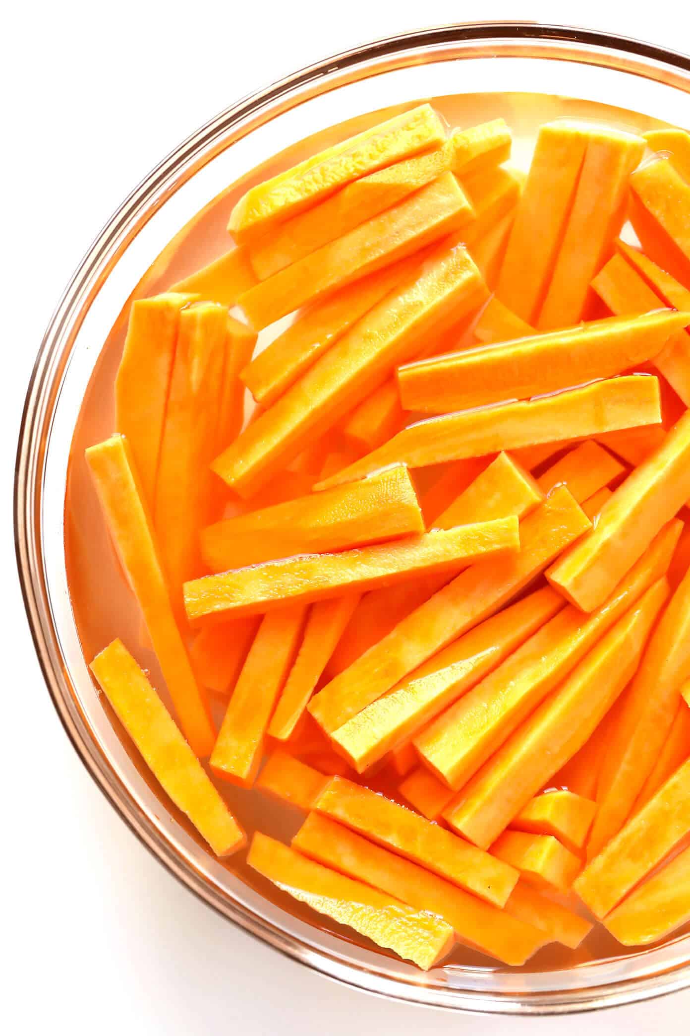 The BEST Baked Sweet Potato Fries Recipe! As in, ultra crispy, perfectly seasoned, and irresistibly delicious. Perfect when served as an appetizer, side dish, or snack. And also naturally gluten-free, vegan and vegetarian. | Gimme Some Oven #sweetpotato #fries #healthy #baked #side #snack #appetizer #gameday #recipe How To Make Baked Sweet Potato Fries -- Soak In Cold Water For 30 Minutes
