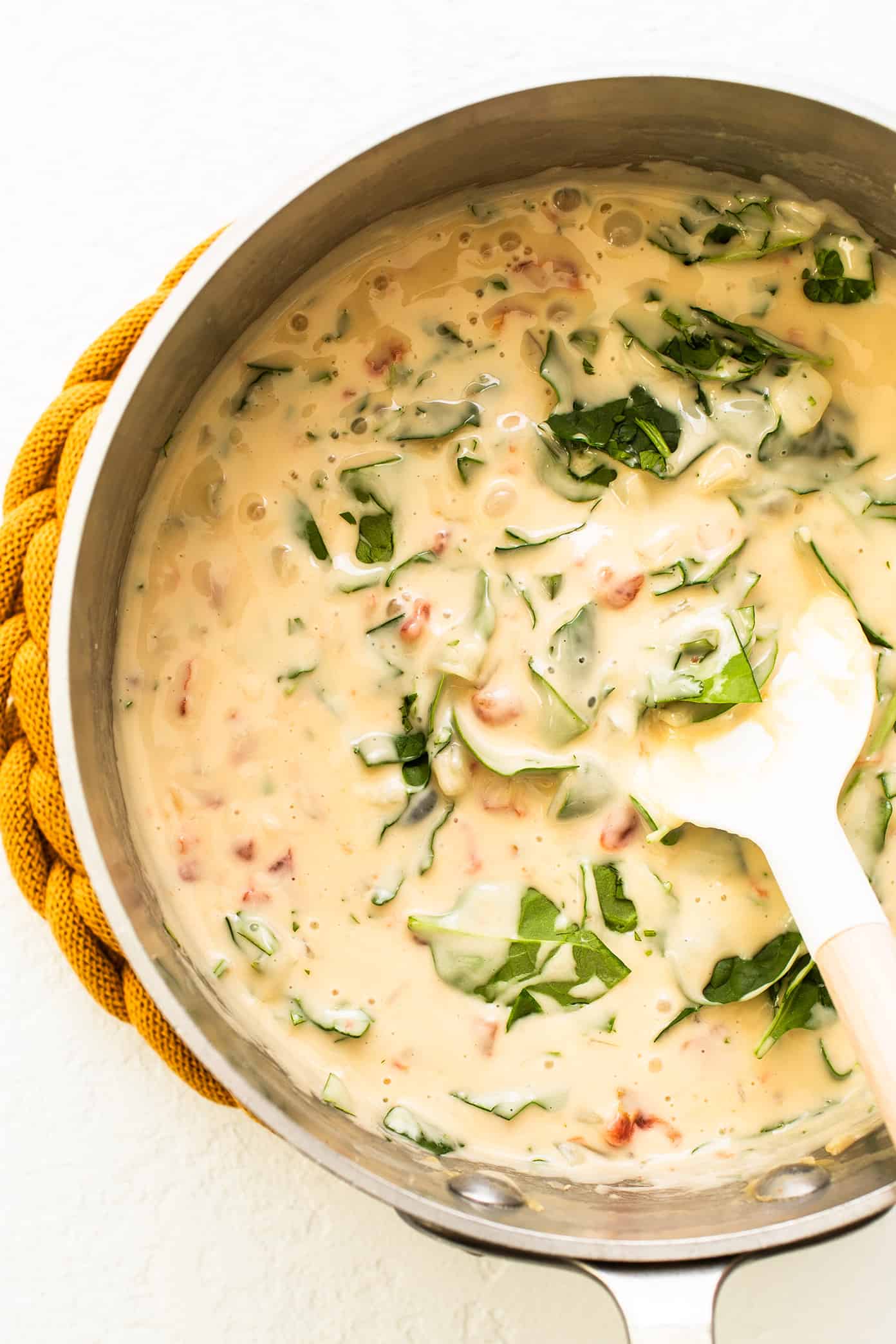 This queso blanco (white cheese dip) recipe is easy to make in about 20 minutes, perfectly melty and scoop-able, and irresistibly delicious. Easy to make with spinach, tomatoes, chiles and the perfect blend of melting cheeses in just 15 minutes, and always everyone's favorite appetizer! | gimmesomeoven.com Queso Blanco in Saucepan