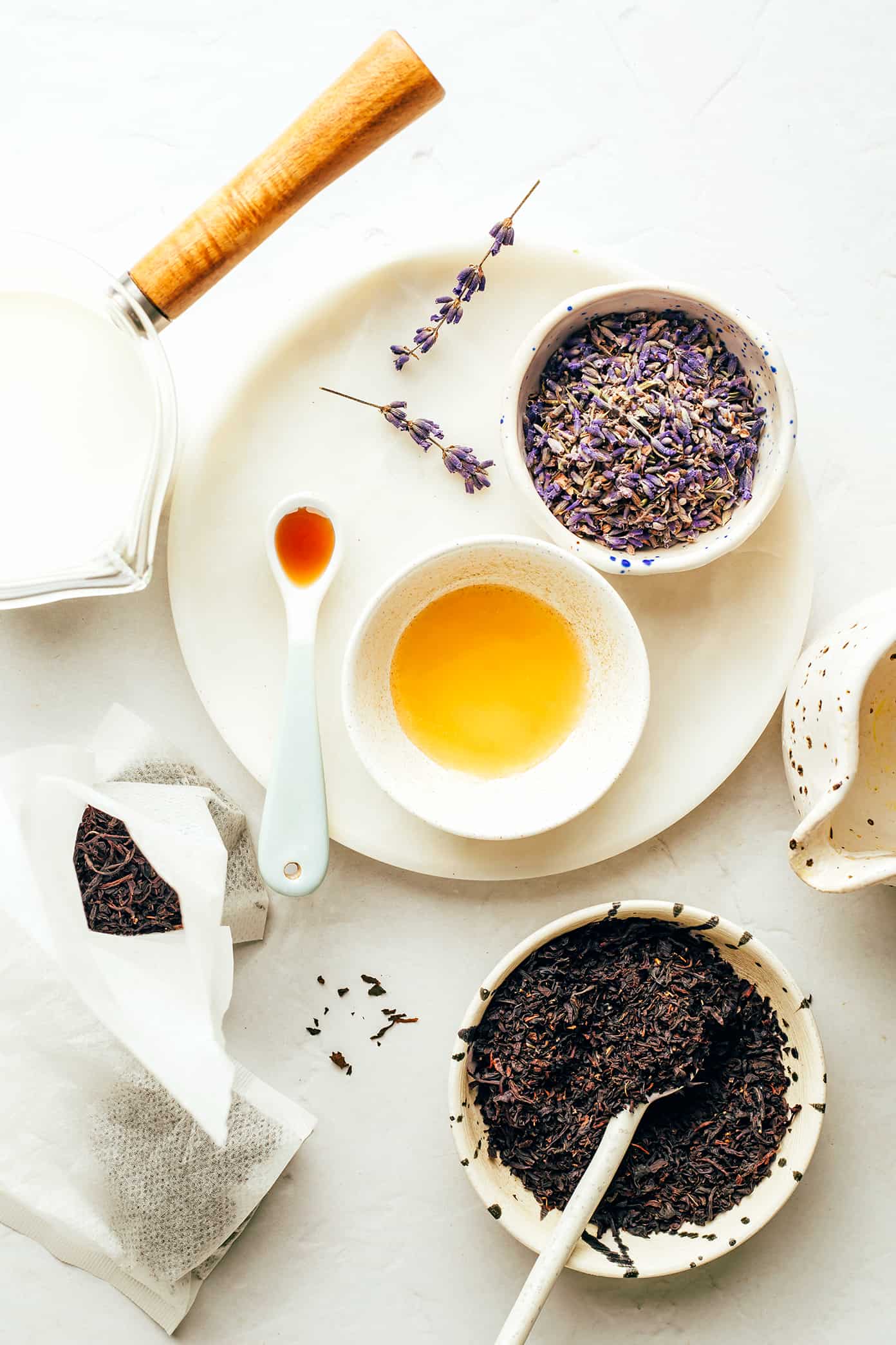 This cozy London Fog (Earl Grey) latte recipe is easy to make hot or iced and brewed with a lovely hint of lavender, vanilla, honey and your choice of milk. It's the perfect cozy drink to warm you up in the winter or a refreshing drink to cool off in the summer, and always so delicious! | gimmesomeoven.com London Fog Latte Ingredients