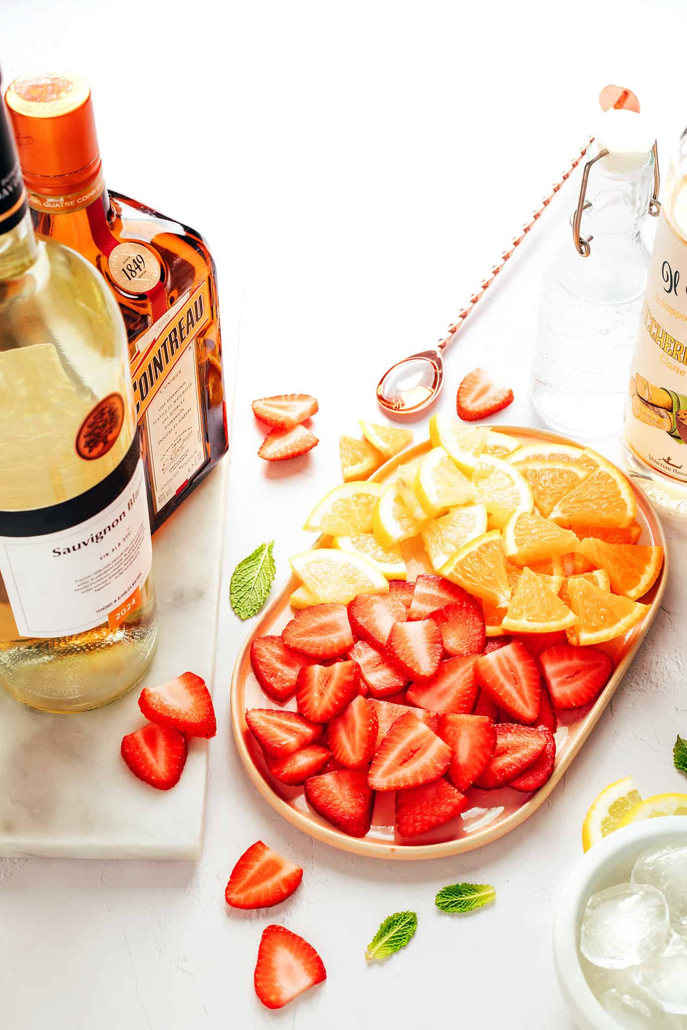 This easy strawberry sangria recipe is made with fresh strawberries, citrus, white wine, and orange liqueur for a refreshing and fruity summer drink. | gimmesomeoven.com strawberry sangria ingredients