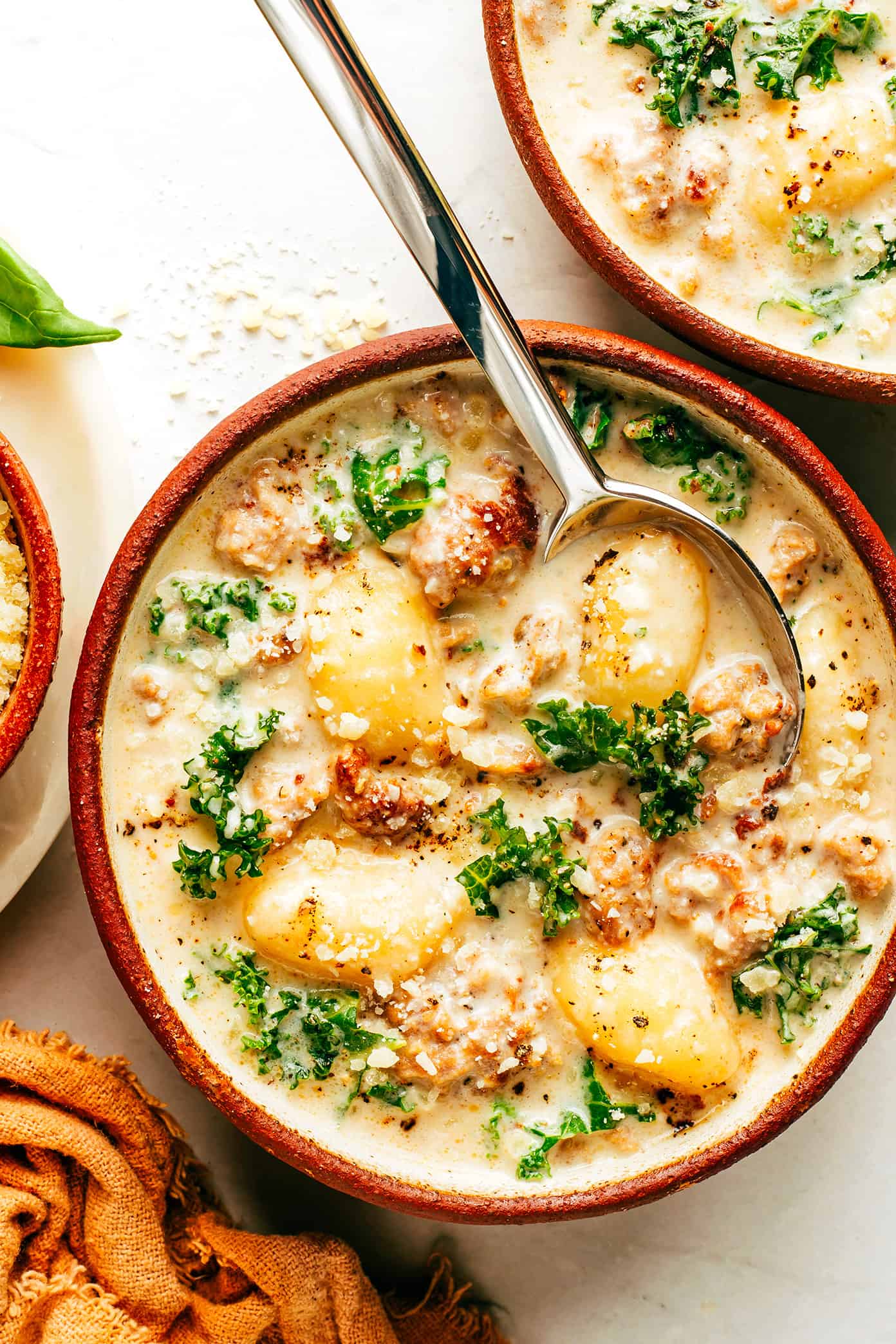 This easy Zuppa Toscana recipe, inspired by the Olive Garden version, uses store-bought gnocchi as a shortcut to bring this delicious creamy sausage and kale soup together in less than 30 minutes. A gluten-free dinner recipe that's easy to also make vegetarian (with plant-based sausage) if you prefer! | gimmesomeoven.com Easy Zuppa Toscana with Gnocchi in Bowl