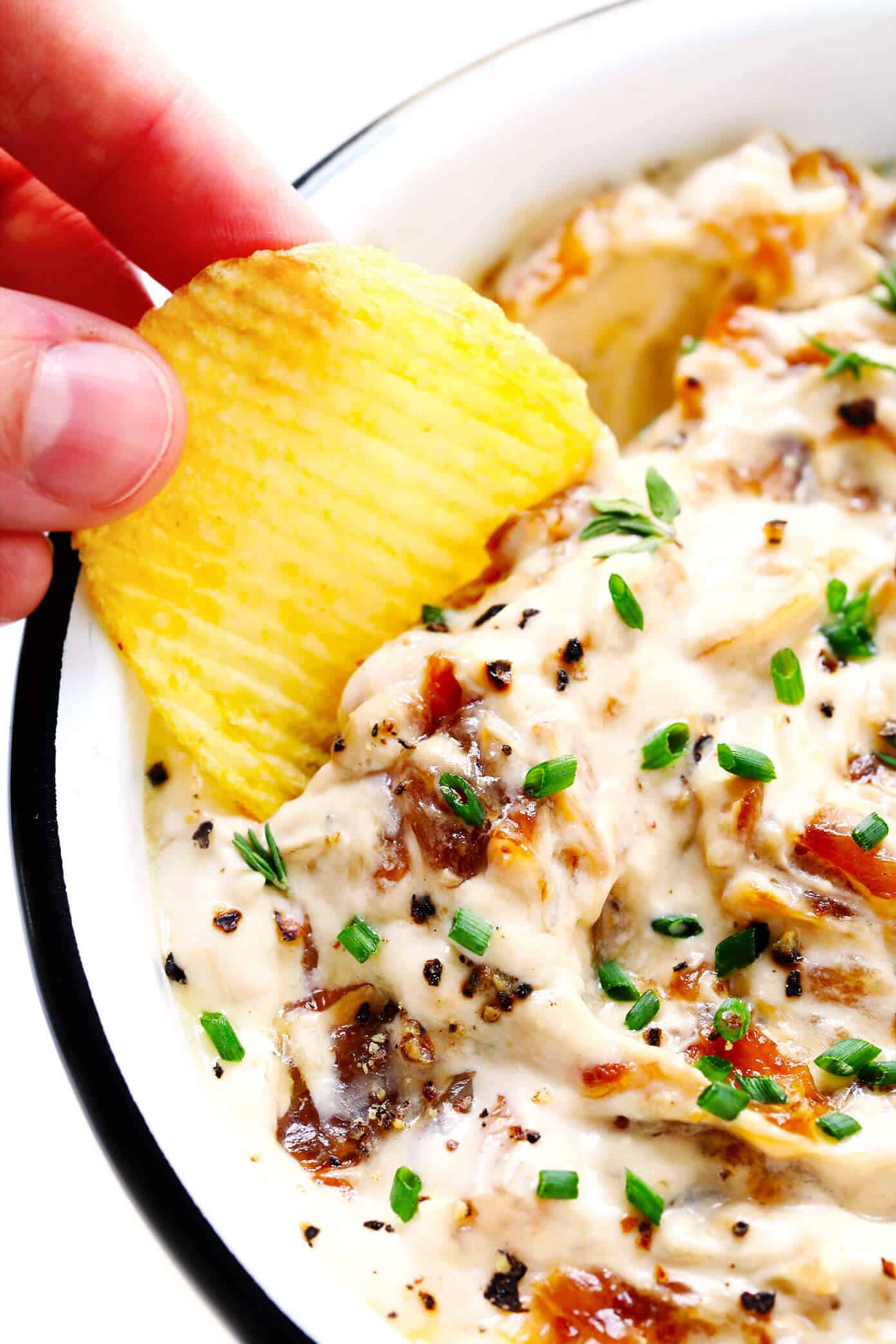 The BEST French onion dip recipe! It's creamy, savory, and a touch sweet (thanks to those delicious caramelized onions)...and downright irresistible. Serve it as a party appetizer, or use it as a spread for burgers, pizza and more! | gimmesomeoven.com #dip #appetizer #frenchonion #vegetarian #glutenfree #entertaining Onion Dip with Potato Chips