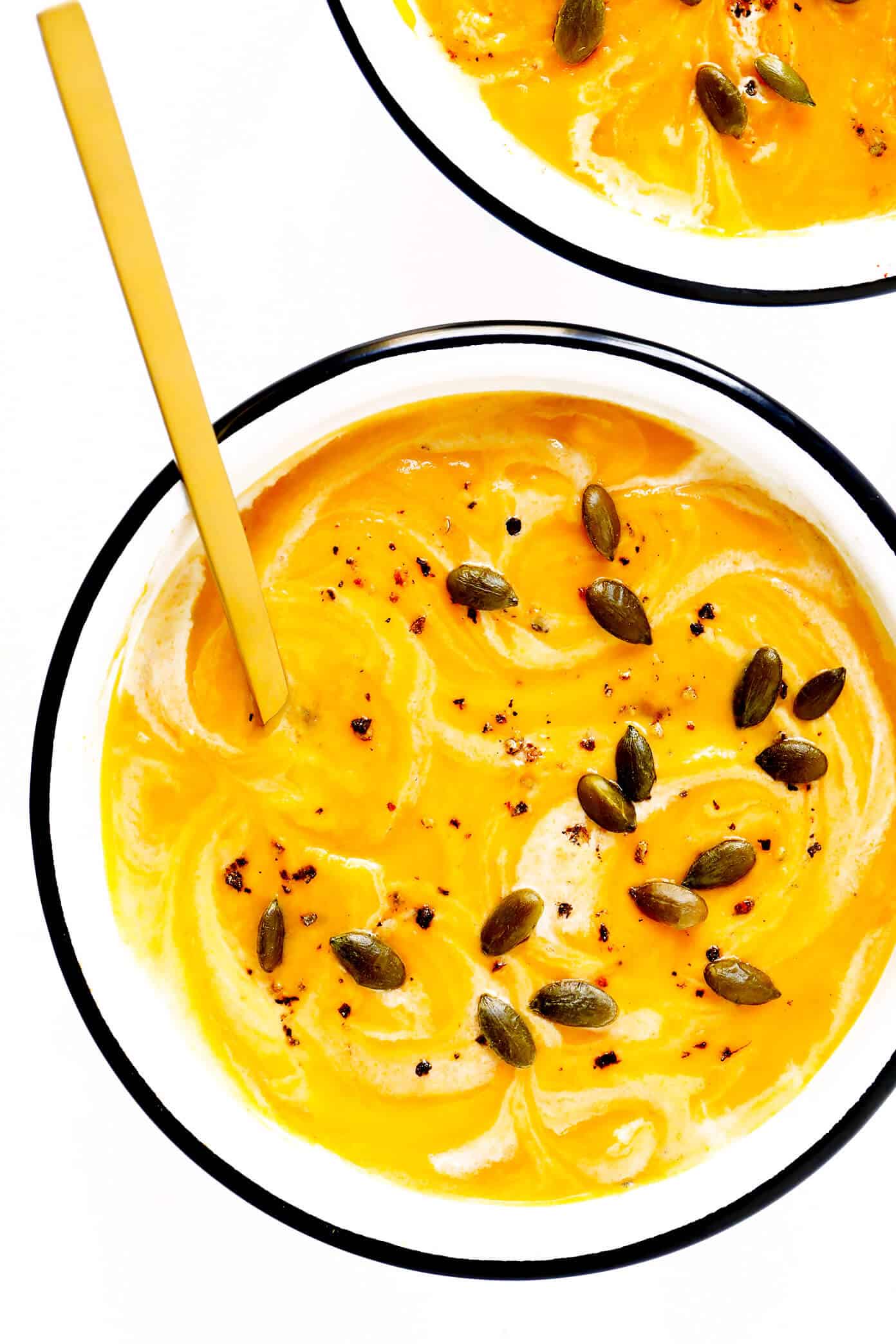 This delicious Butternut Squash Soup recipe is quick and easy to make, loaded up with savory fall vegetables, lightened up with coconut milk (no heavy cream needed), and SO cozy and delicious. Naturally gluten-free, vegetarian, vegan and easy to make in either the Instant Pot, Crock Pot, or on the stovetop. The perfect healthy comfort food dinner recipe for fall or winter! | gimmesomeoven.com Butternut Squash Soup Recipe
