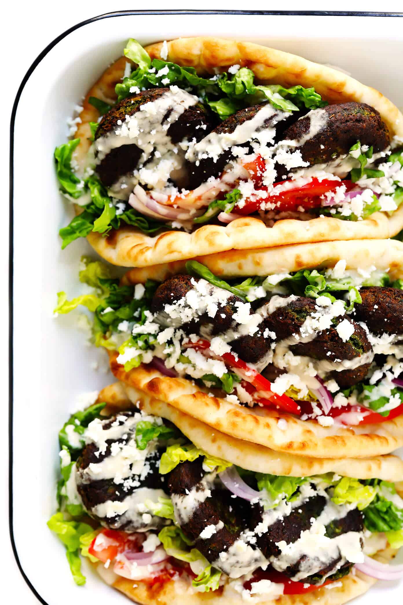 Learn how to make falafel with this easy homemade falafel recipe! It's bursting with zesty fresh fresh flavors, lightly pan-fried (instead of deep-fried), and perfect for falafel wraps, salads, sandwiches and more. Bonus, it's also naturally vegan and gluten-free. | gimmesomeoven.com #falafel #wrap #vegetarian #vegan #glutenfree #healthy #dinner #freezermeals Falafel Sandwiches in Pita Wraps