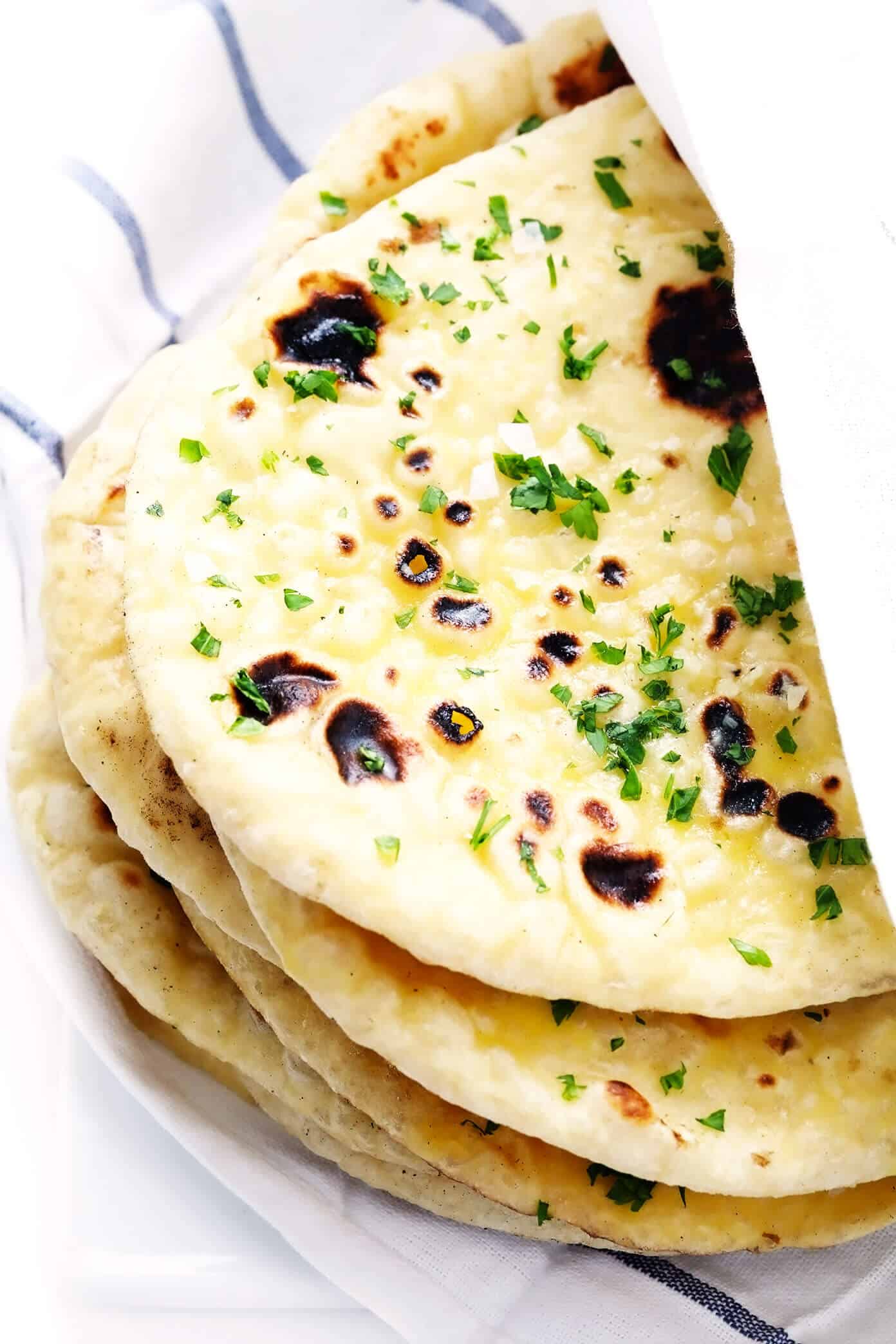 This homemade naan recipe is easy to make, perfectly soft and chewy, and always so delicious. I've included a garlic naan recipe option below too! | gimmesomeoven.com #naan #bread #flatbread #vegetarian #homemade #wrap #garlic Homemade Naan