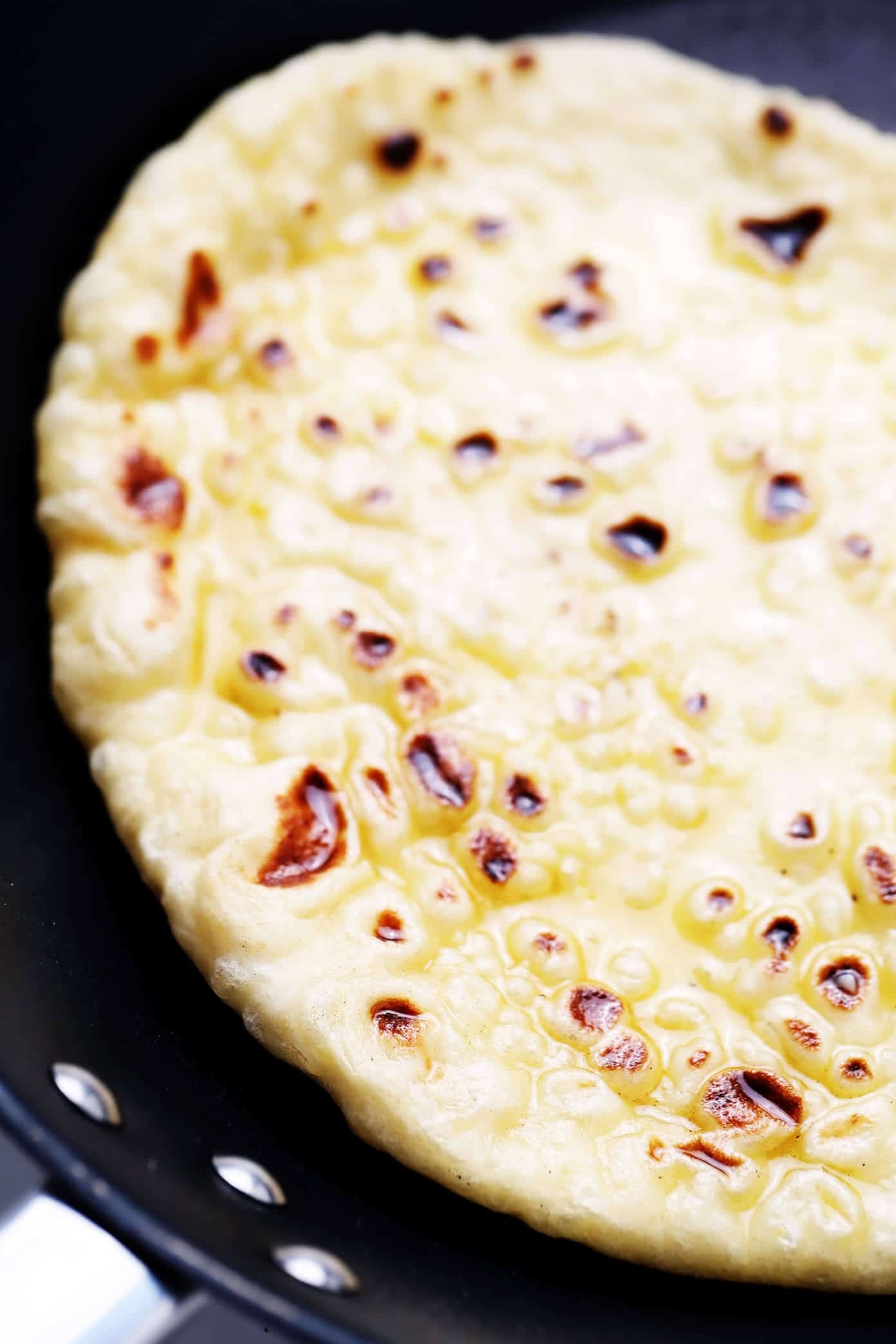 This homemade naan recipe is easy to make, perfectly soft and chewy, and always so delicious. I've included a garlic naan recipe option below too! | gimmesomeoven.com #naan #bread #flatbread #vegetarian #homemade #wrap #garlic Homemade Naan with Garlic Butter