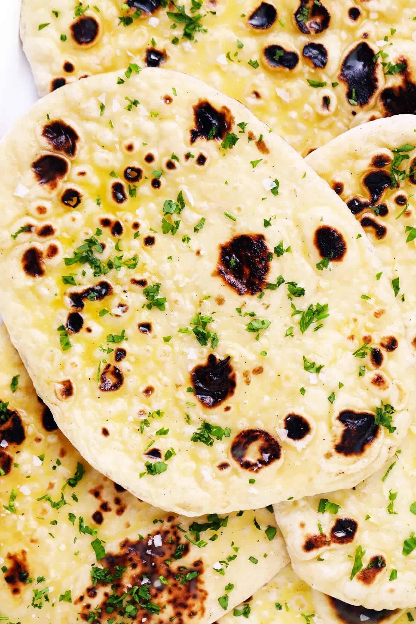 This homemade naan recipe is easy to make, perfectly soft and chewy, and always so delicious. I've included a garlic naan recipe option below too! | gimmesomeoven.com #naan #bread #flatbread #vegetarian #homemade #wrap #garlic Homemade Garlic Naan In A Stack