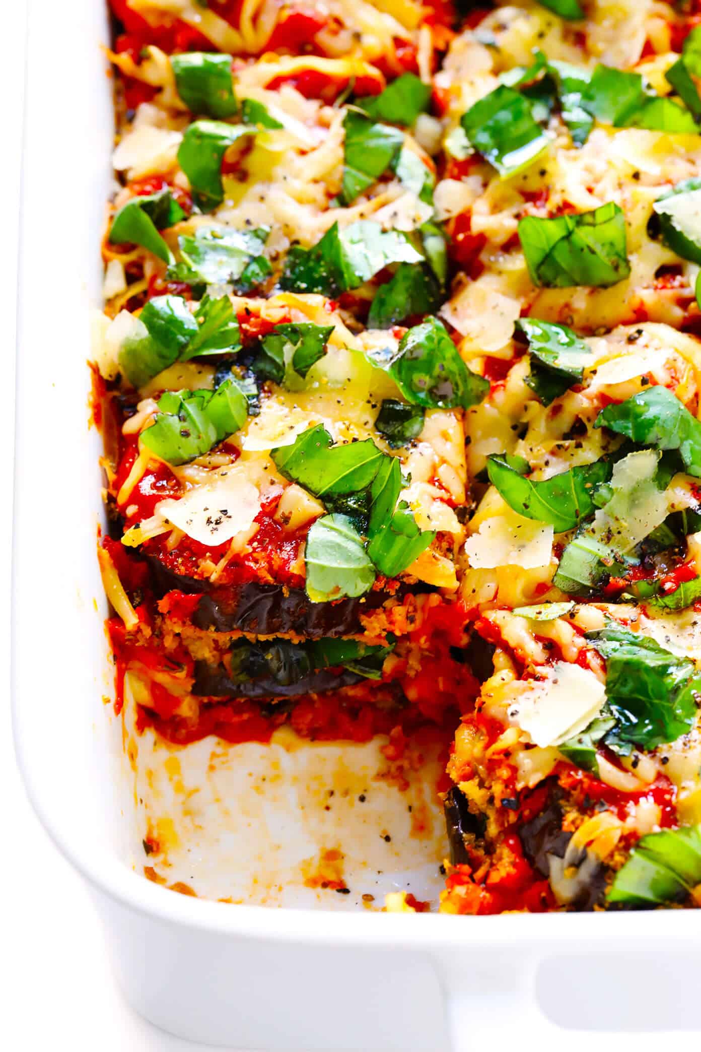 This Baked Eggplant Parmesan recipe is lightened up a bit with Panko-crusted baked (instead of fried) roasted eggplant, and layered with marinara tomato sauce, mozzarella cheese, fresh basil, and lots and lots of Parmesan. It's the perfect vegetarian casserole for Italian night, and always winner! | gimmesomeoven.com #eggplant #parmesan #vegetarian #casserole #glutenfree #italian #comfortfood #lasagna Baked Eggplant Parmesan