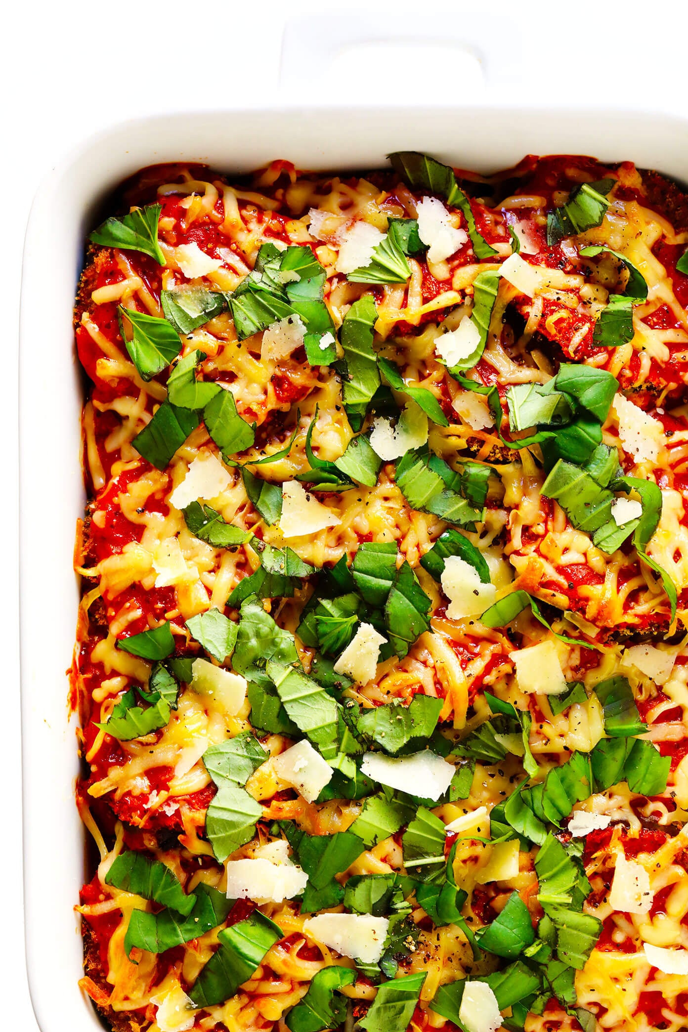 This Baked Eggplant Parmesan recipe is lightened up a bit with Panko-crusted baked (instead of fried) roasted eggplant, and layered with marinara tomato sauce, mozzarella cheese, fresh basil, and lots and lots of Parmesan. It's the perfect vegetarian casserole for Italian night, and always winner! | gimmesomeoven.com #eggplant #parmesan #vegetarian #casserole #glutenfree #italian #comfortfood #lasagna Healthy Eggplant Parmesan Recipe with Basil