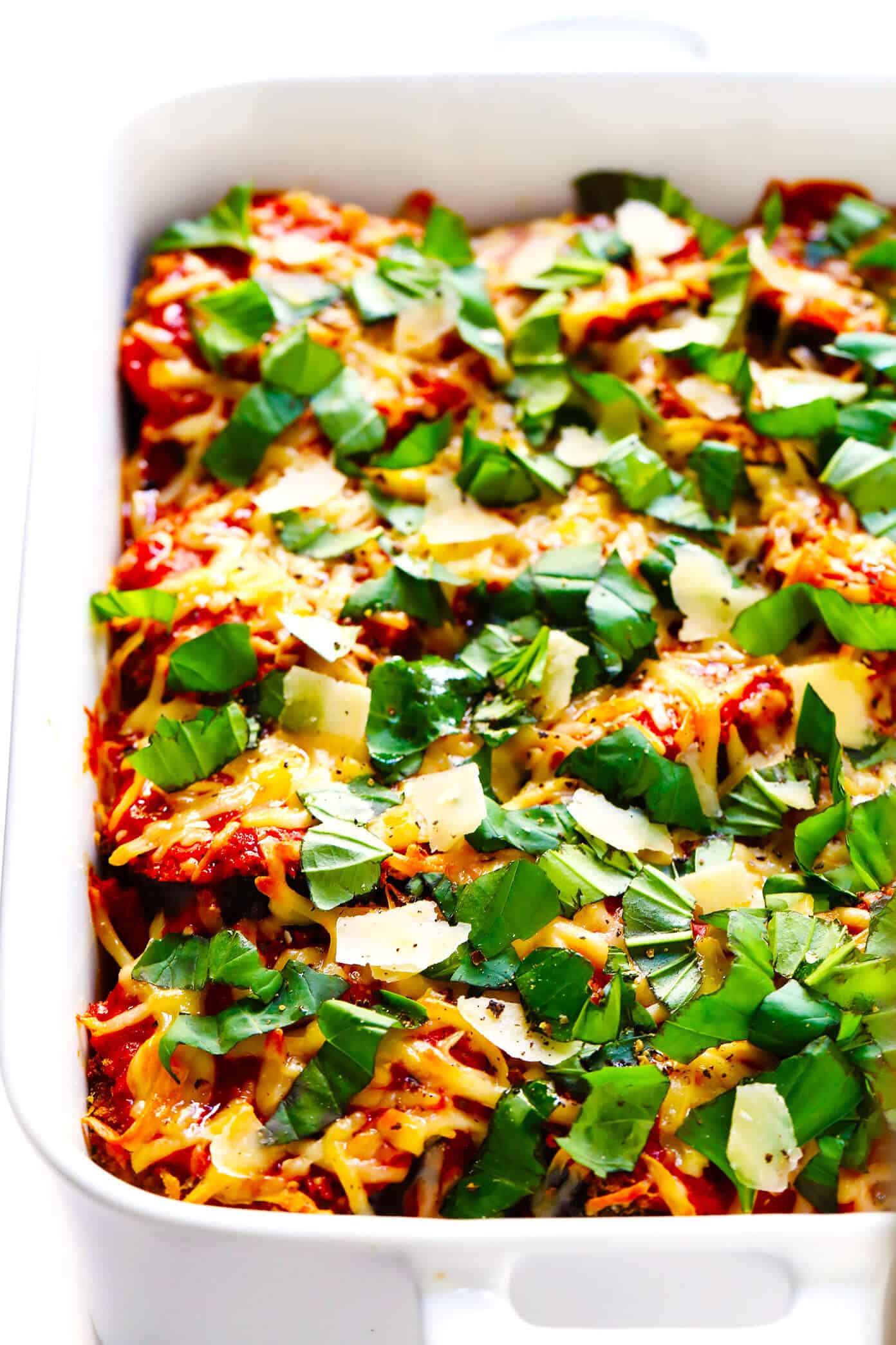 This Baked Eggplant Parmesan recipe is lightened up a bit with Panko-crusted baked (instead of fried) roasted eggplant, and layered with marinara tomato sauce, mozzarella cheese, fresh basil, and lots and lots of Parmesan. It's the perfect vegetarian casserole for Italian night, and always winner! | gimmesomeoven.com #eggplant #parmesan #vegetarian #casserole #glutenfree #italian #comfortfood #lasagna Best Eggplant Parmesan Recipe