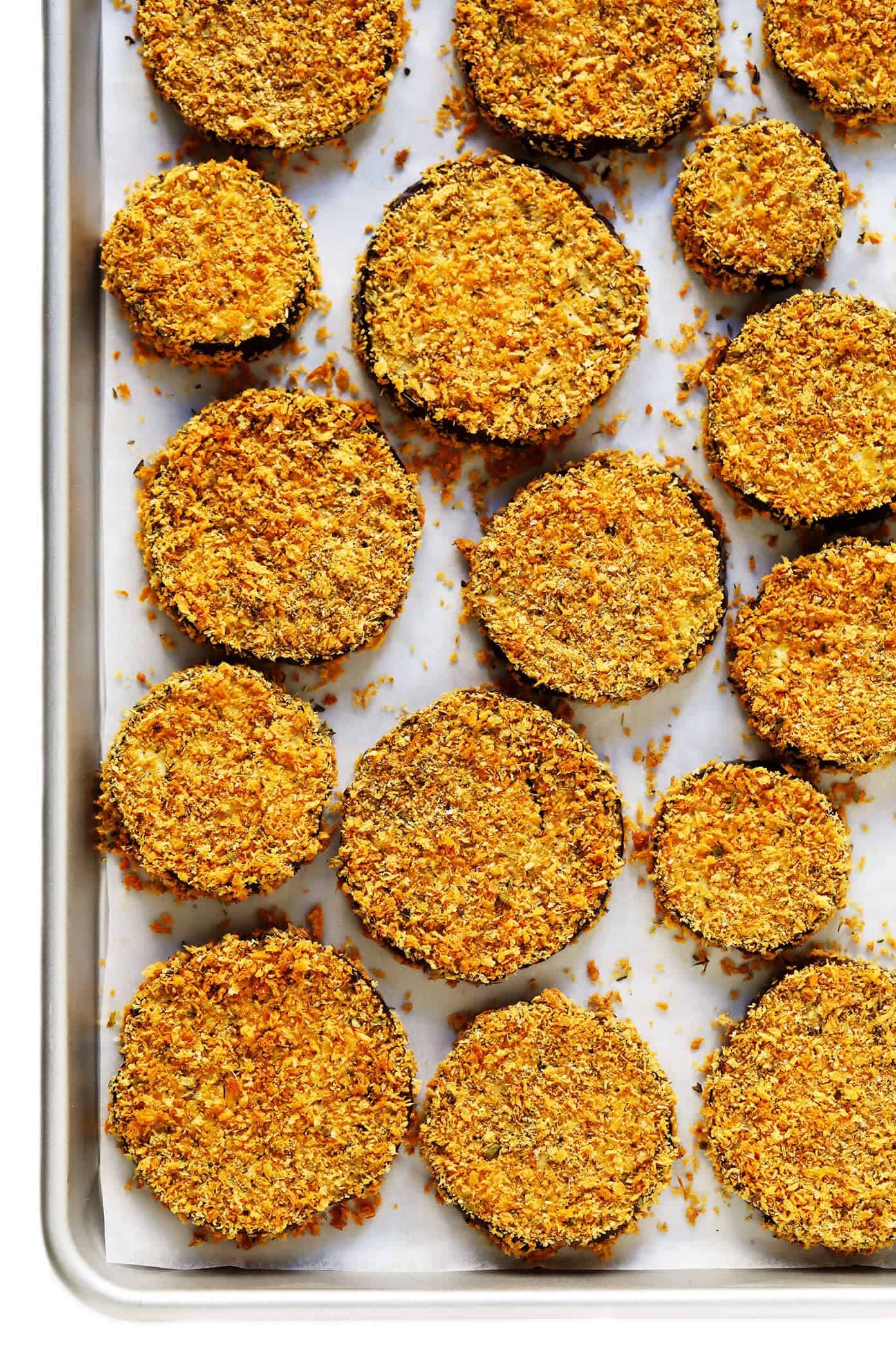 This Baked Eggplant Parmesan recipe is lightened up a bit with Panko-crusted baked (instead of fried) roasted eggplant, and layered with marinara tomato sauce, mozzarella cheese, fresh basil, and lots and lots of Parmesan. It's the perfect vegetarian casserole for Italian night, and always winner! | gimmesomeoven.com #eggplant #parmesan #vegetarian #casserole #glutenfree #italian #comfortfood #lasagna Crispy Oven-Fried Panko-Crusted Roasted Eggplant