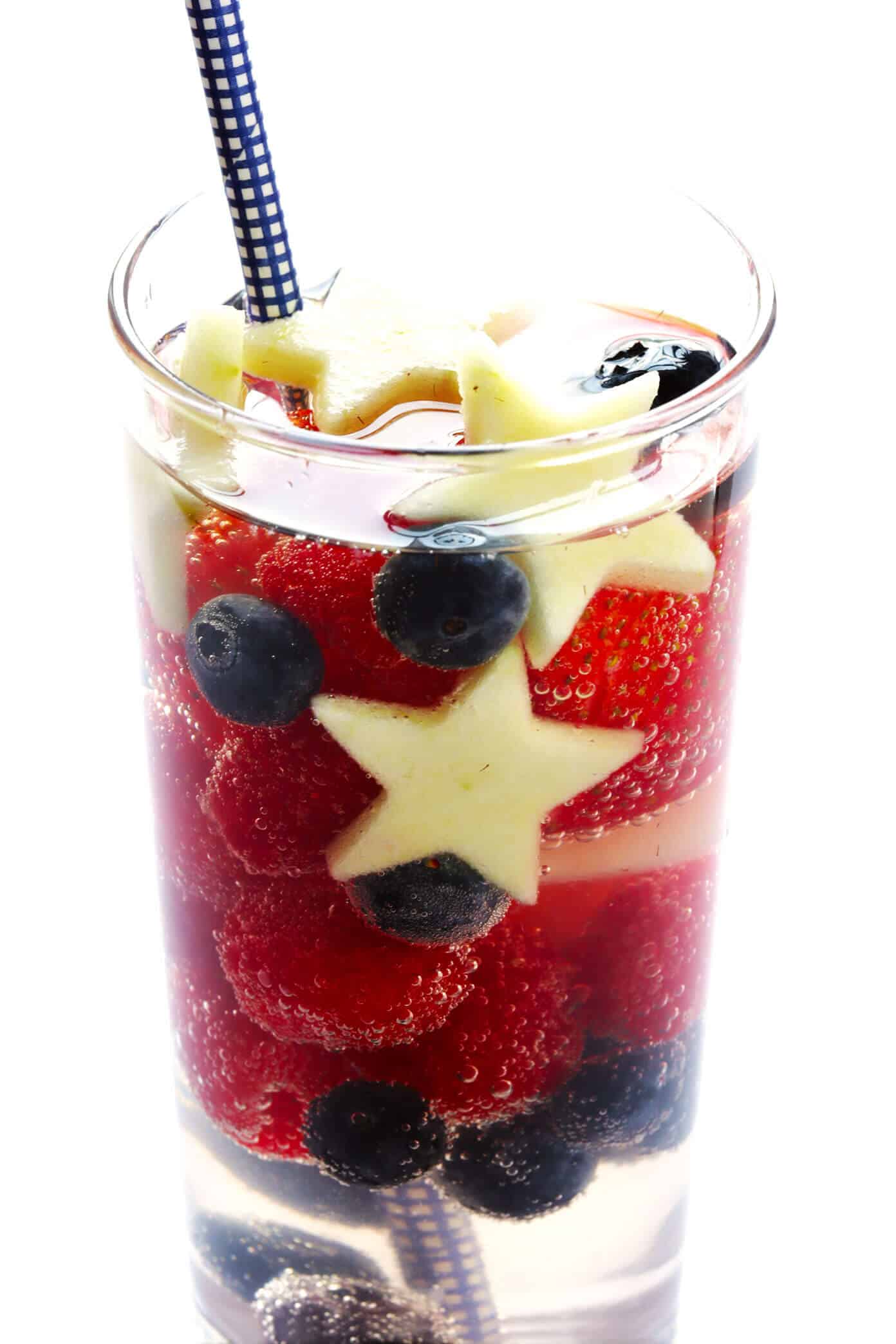 This Red, White and Blue Sparkling Sangria recipe is the perfect drink for the 4th of July or Memorial Day! It's easy to make with strawberries, blueberries, apples and your choice of wine...and always a party favorite! | gimmesomeoven.com #sangria #redwhiteandblue #cocktail #drink #4thofjuly #memorialday Red White and Blue Sangria for 4th of July