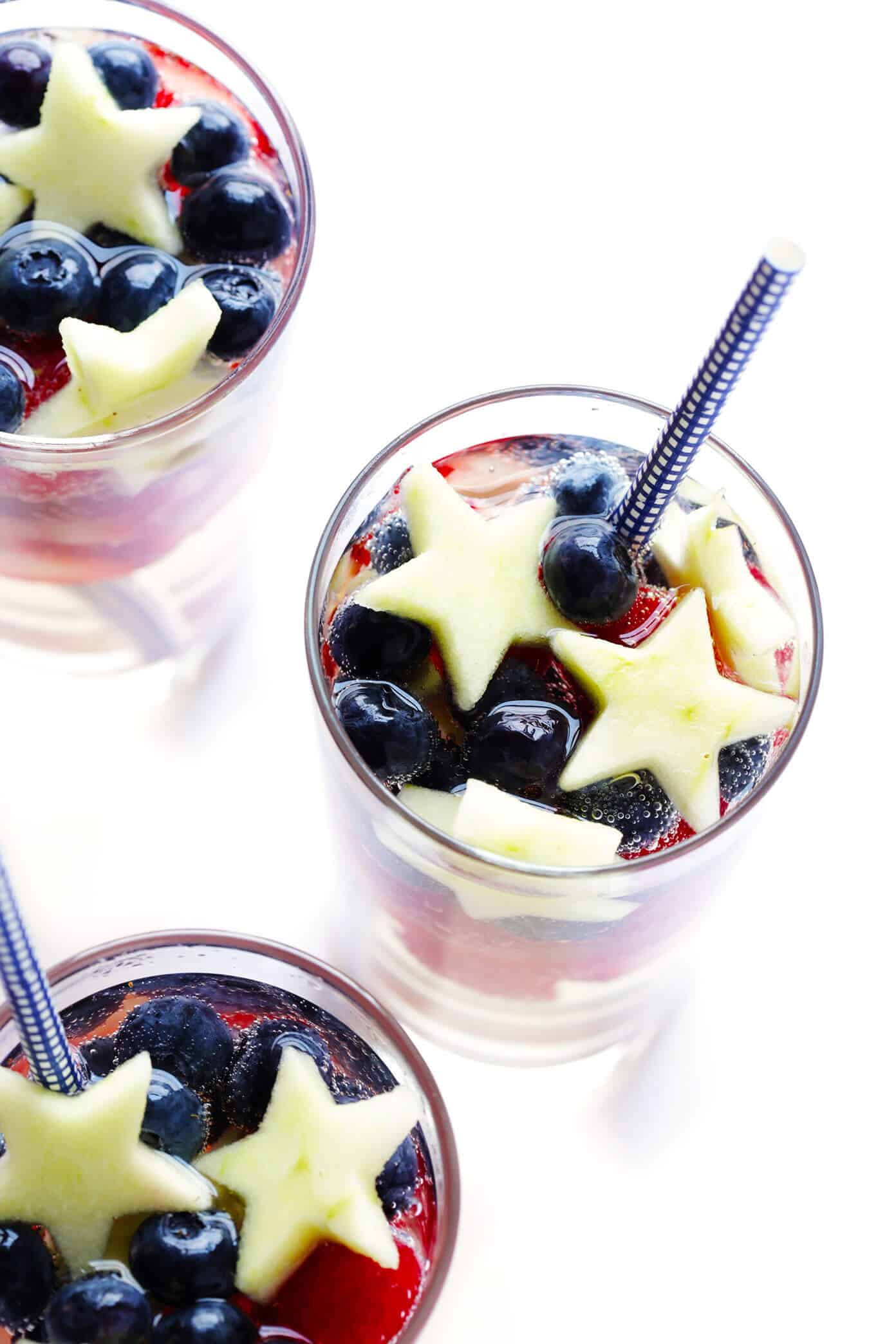 This Red, White and Blue Sparkling Sangria recipe is the perfect drink for the 4th of July or Memorial Day! It's easy to make with strawberries, blueberries, apples and your choice of wine...and always a party favorite! | gimmesomeoven.com #sangria #redwhiteandblue #cocktail #drink #4thofjuly #memorialday Red White and Blue Sangria Recipe