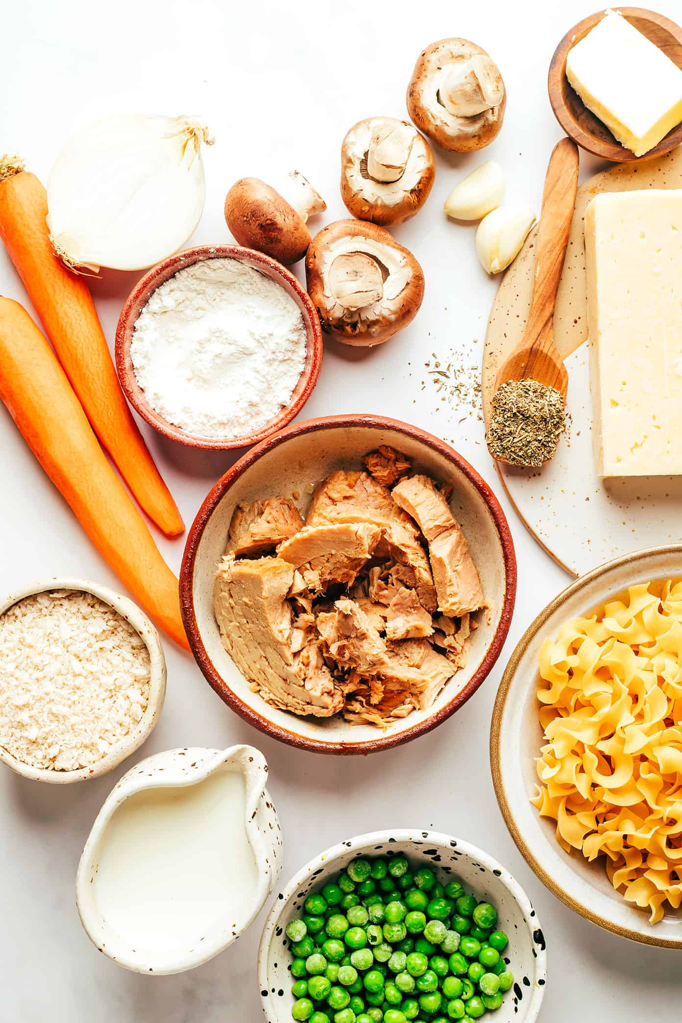 This lightened-up tuna casserole recipe is tossed with a creamy cheddar garlic-herb sauce, lots of veggies, tender egg noodles and a crispy Panko topping. A simple and delicious weeknight dinner recipe that's ready to go in just 40 minutes. | gimmesomeoven.com Tuna Casserole Ingredients