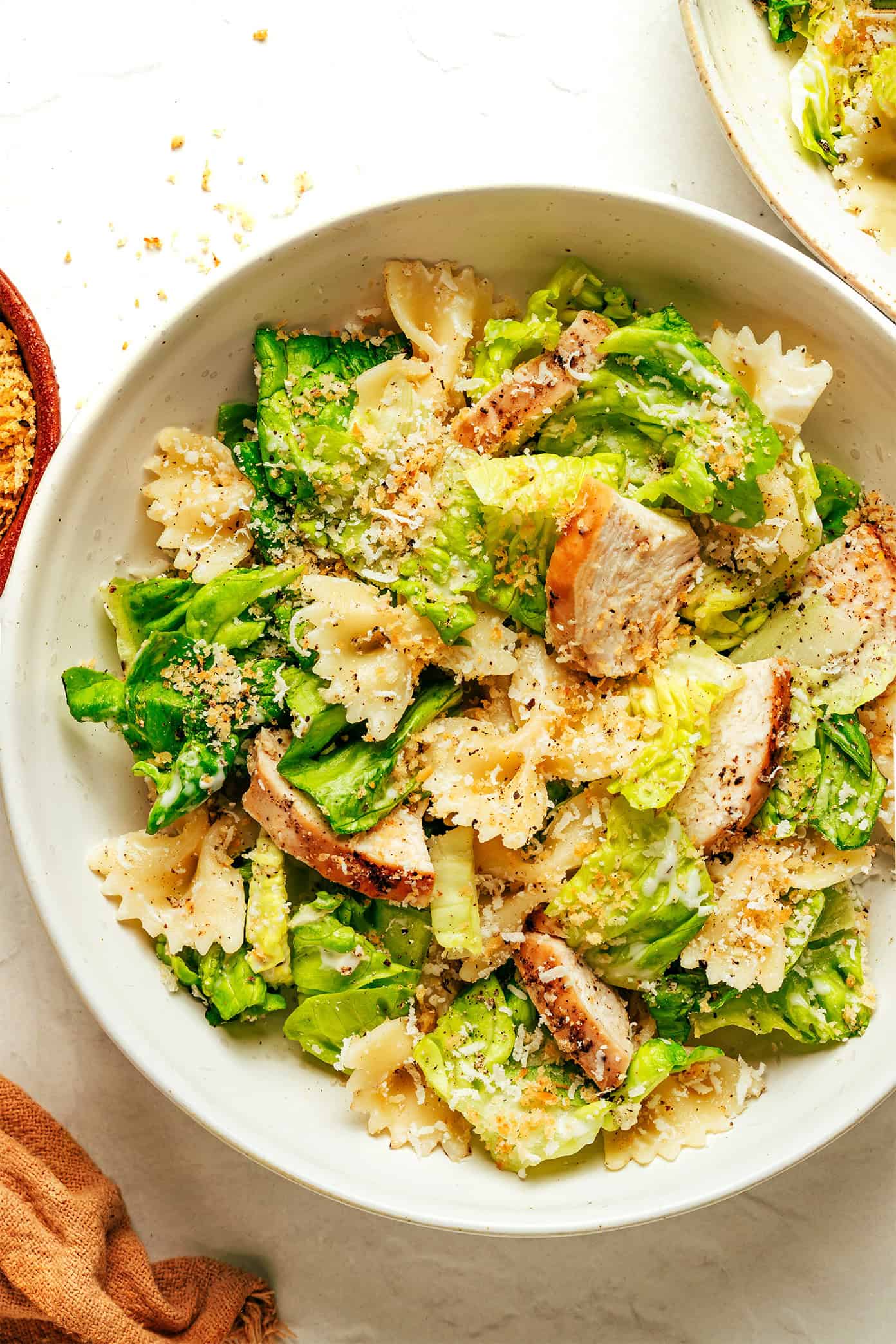 This Chicken Caesar Pasta Salad recipe is tossed with my favorite Caesar dressing, lots of Parmesan cheese, and the yummiest garlicky breadcrumbs. Feel free to use a different protein (such as salmon, shrimp, Italian sausage, bacon or roasted chickpeas) for the chicken if you prefer! | gimmesomeoven.com Chicken Caesar Pasta Salad recipe