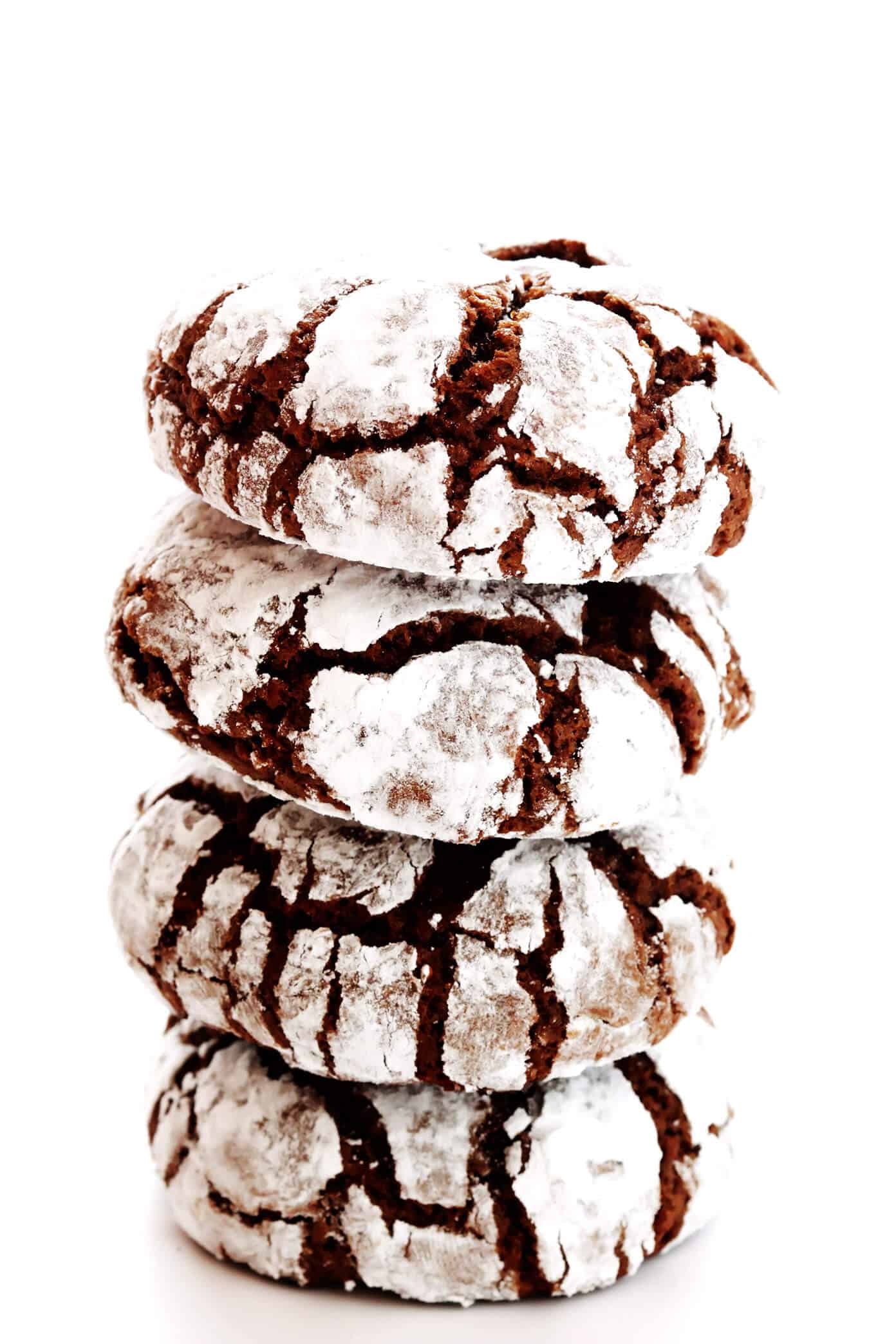 This chocolate crinkle cookies recipe (also known as snowballs) is easy to make and perfectly fudgy and dusted with powdered sugar. A classic dessert for Christmas and the holidays! | gimmesomeoven.com #chocolate #crinkle #cookies #dessert #christmas #holiday #baking Stack of Chocolate Crinkle Cookies