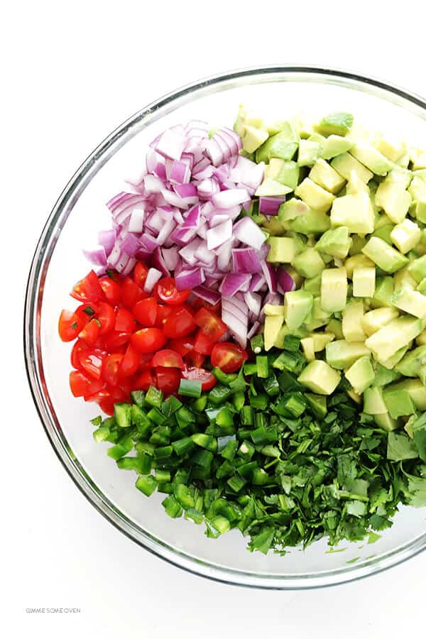 This chunky guacamole recipe is quick and easy to make, it's naturally gluten-free and vegan, and it's always a hit with a crowd! Perfect for game day, or as an appetizer or snack any ol' day. | gimmesomeoven.com