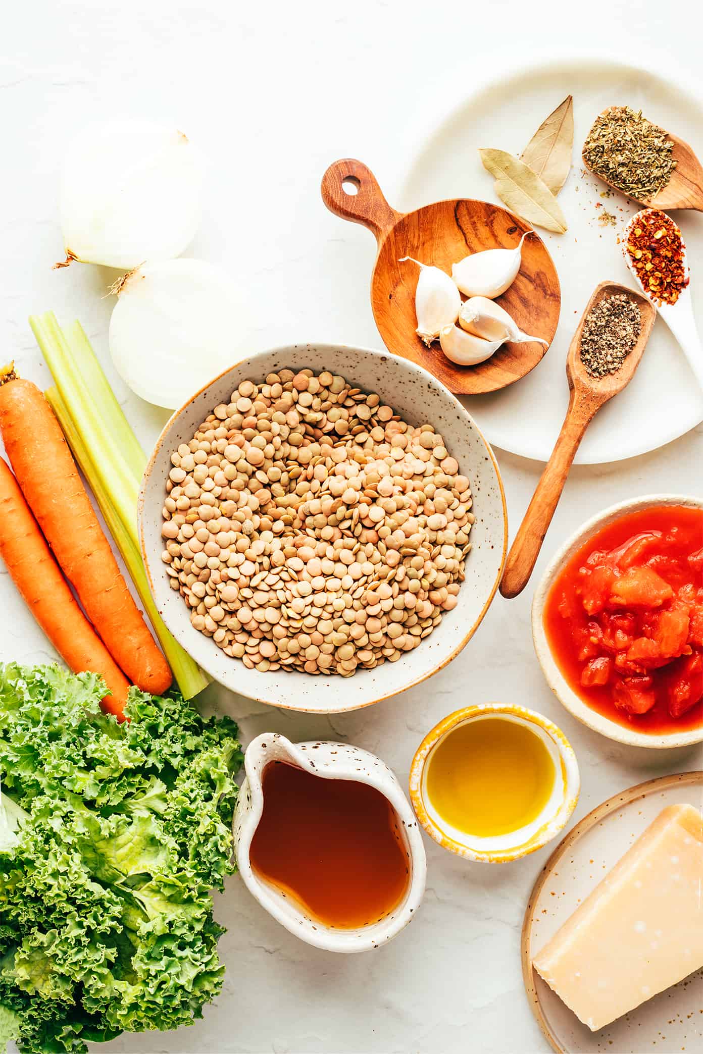 This Italian-inspired lentil soup recipe is made with a simple mix of veggies, lentils, greens and simmered in a tomato-herb broth and served with a garnish of basil and Parmesan. A simple vegetarian and gluten-free dinner recipe that's always so comforting and delicious! | gimmesomeoven.com Italian Lentil Soup Ingredients