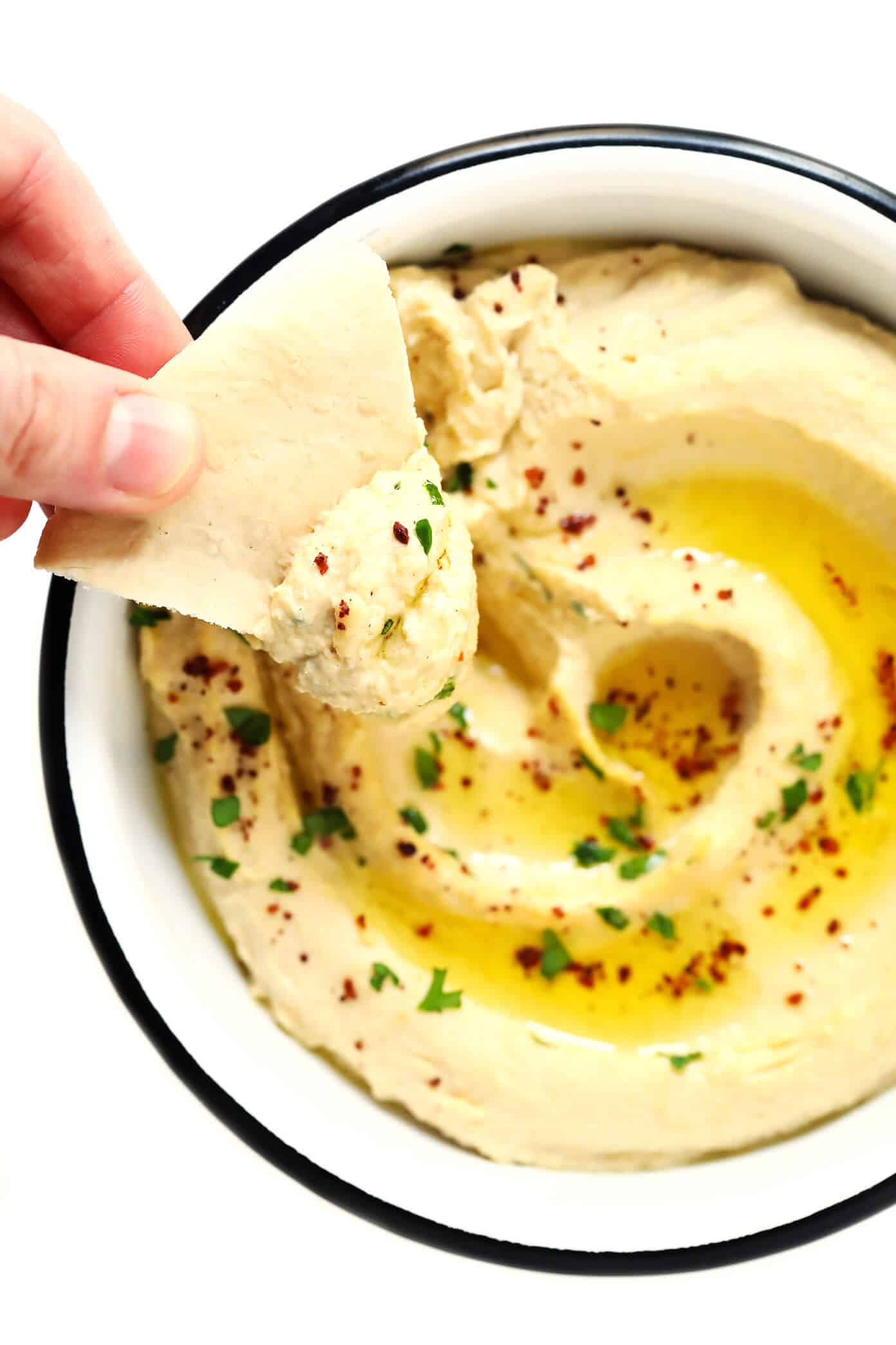 Hummus Toast is fun to customize with your favorite toppings, and makes for a delicious easy breakfast, lunch, dinner or healthy snack! Read more for details on 8 of our favorite toppings -- "everything", avocado, elote, tomato basil, lox, fried egg, mediterranean or honey banana. | gimmesomeoven.com #hummus #toast #healthy #breakfast #dinner #lunch #snack Homemade Hummus for Hummus Toast