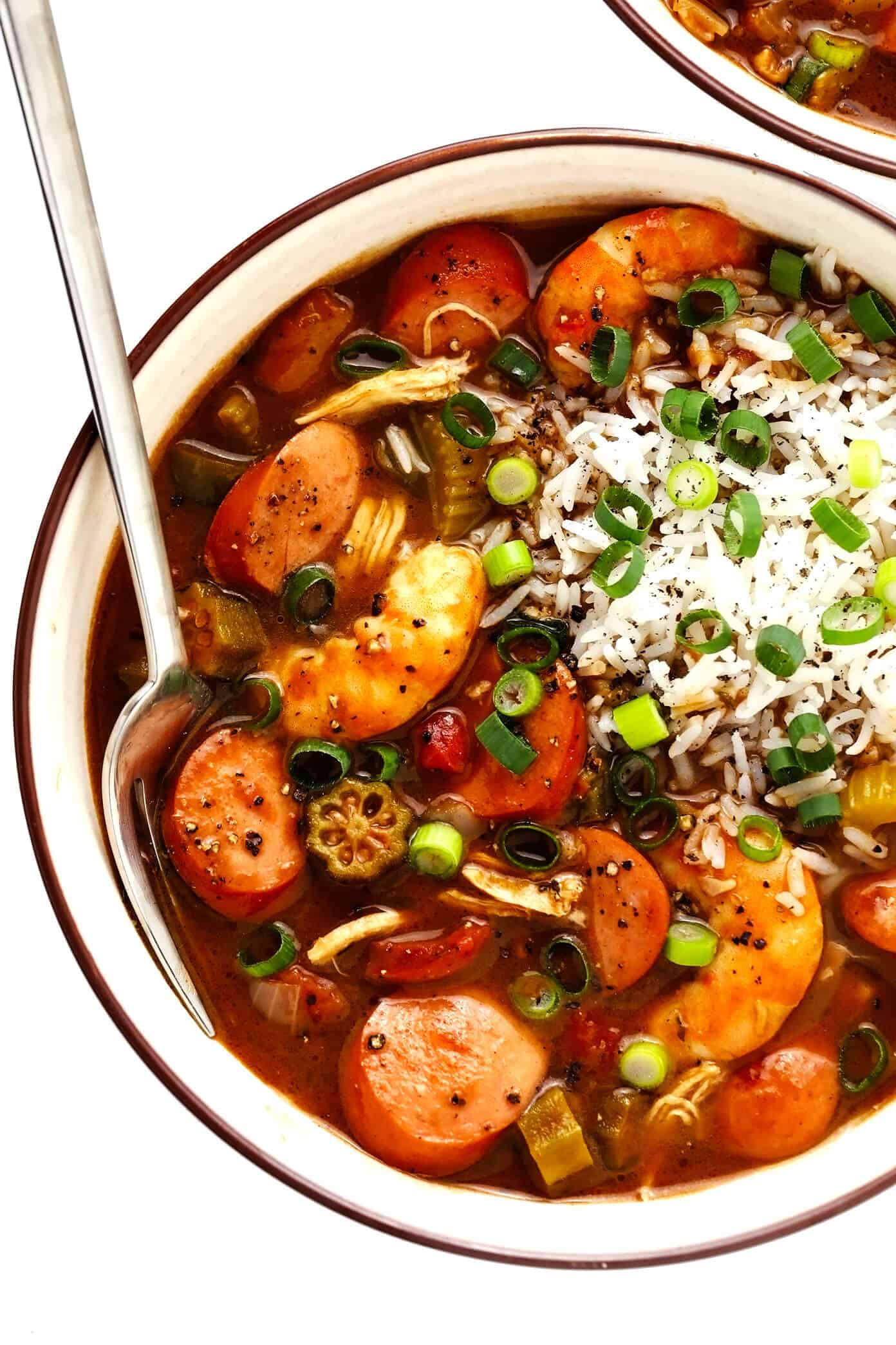 This Creole-style gumbo recipe is made with a richly-flavored dark roux, your choice of proteins (chicken, sausage and/or seafood), lots of veggies, and served over rice. So hearty, rich, and delicious! | gimmesomeoven.com #gumbo #soup #stew #creole #cajun #neworleans #mardigras #rice #dinner Favorite Gumbo