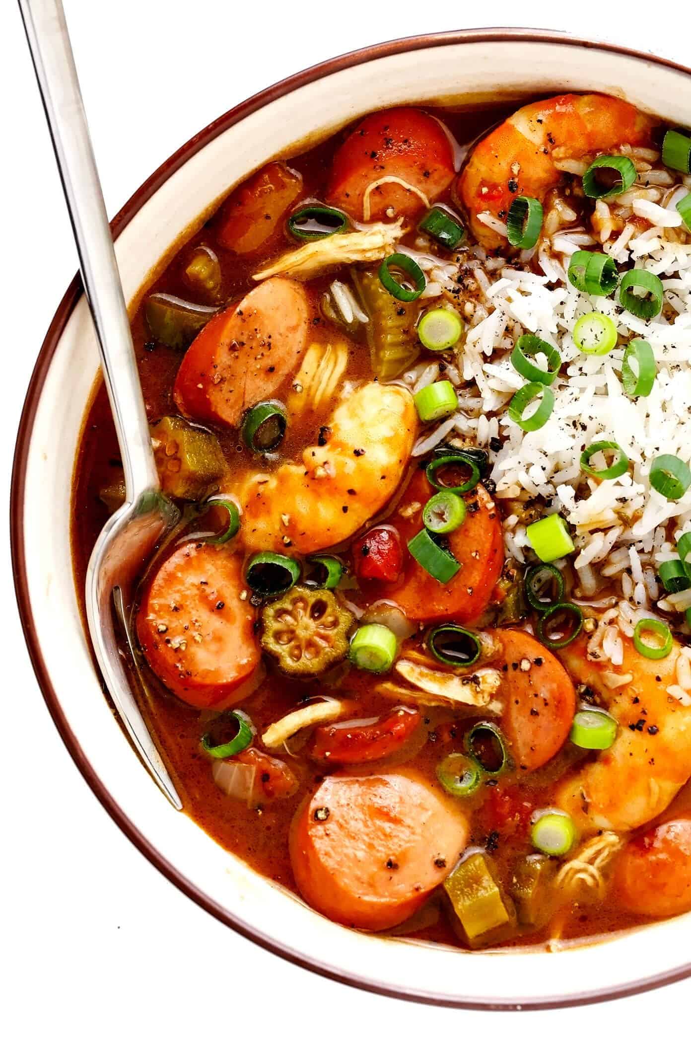 This Creole-style gumbo recipe is made with a richly-flavored dark roux, your choice of proteins (chicken, sausage and/or seafood), lots of veggies, and served over rice. So hearty, rich, and delicious! | gimmesomeoven.com #gumbo #soup #stew #creole #cajun #neworleans #mardigras #rice #dinner Bowl of Gumbo with Andouille Sausage, Chicken and Shrimp