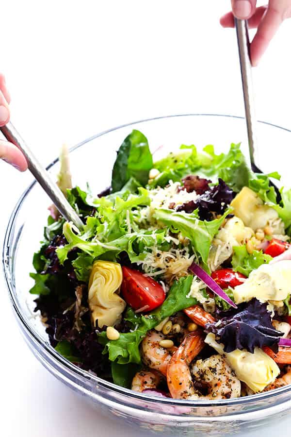 This Shrimp and Artichoke Green Salad is made with easy Italian-herb shrimp, artichoke hearts, tomatoes, pine nuts, and then it's tossed in a zesty lemon vinaigrette. It's one of my all-time favorite salads! | gimmesomeoven.com