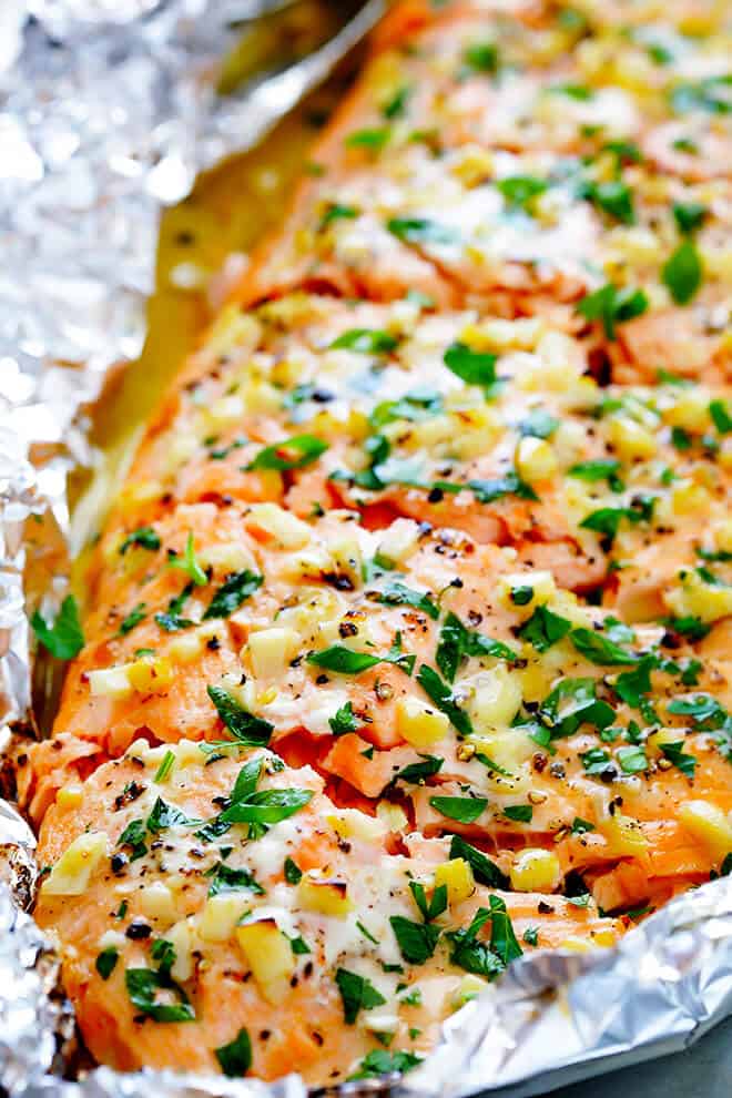 This Garlic Lovers Salmon In Foil recipe only takes a few minutes to prep, it's made with a SUPER delicious lemon garlic butter sauce, and it's always a crowd pleaser! Directions included for how cook it on the grill or in the oven. | gimmesomeoven.com