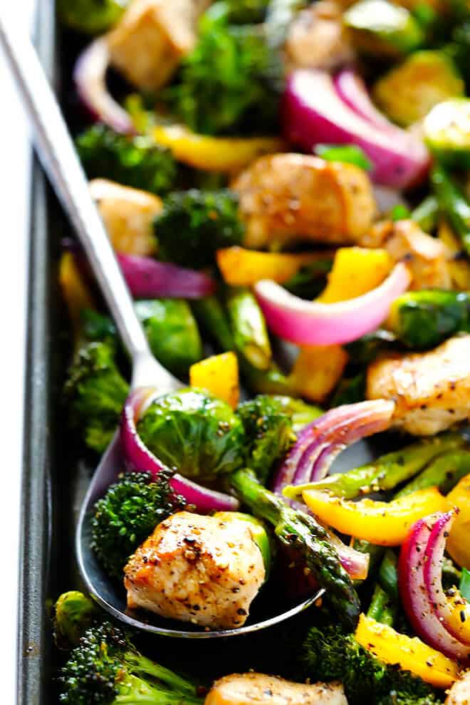 This delicious Sheet Pan Chicken and Veggies "Stir Fry" dinner recipe is quick and easy to prepare, and made with a delicious sesame-soy dressing that everyone will love. Plus, it's easy to make-ahead and refrigerate if you'd like to do some meal planning for the week! | gimmesomeoven.com