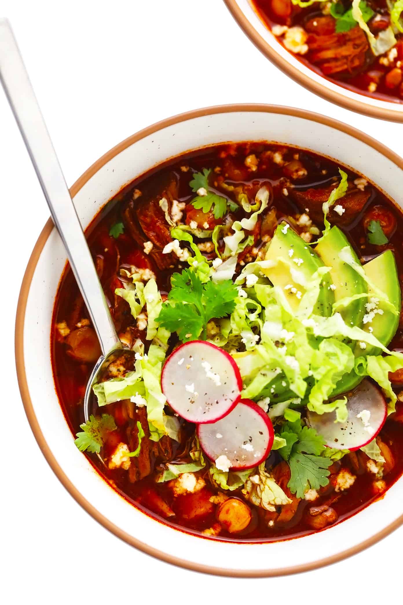 This traditional Mexican pozole recipe is made with tender pork and hominy and simmered in the most delicious chile broth, then piled high with your favorite fresh toppings. Crock-Pot and Instant Pot options for this soup are included too! | gimmesomeoven.com Pozole Rojo