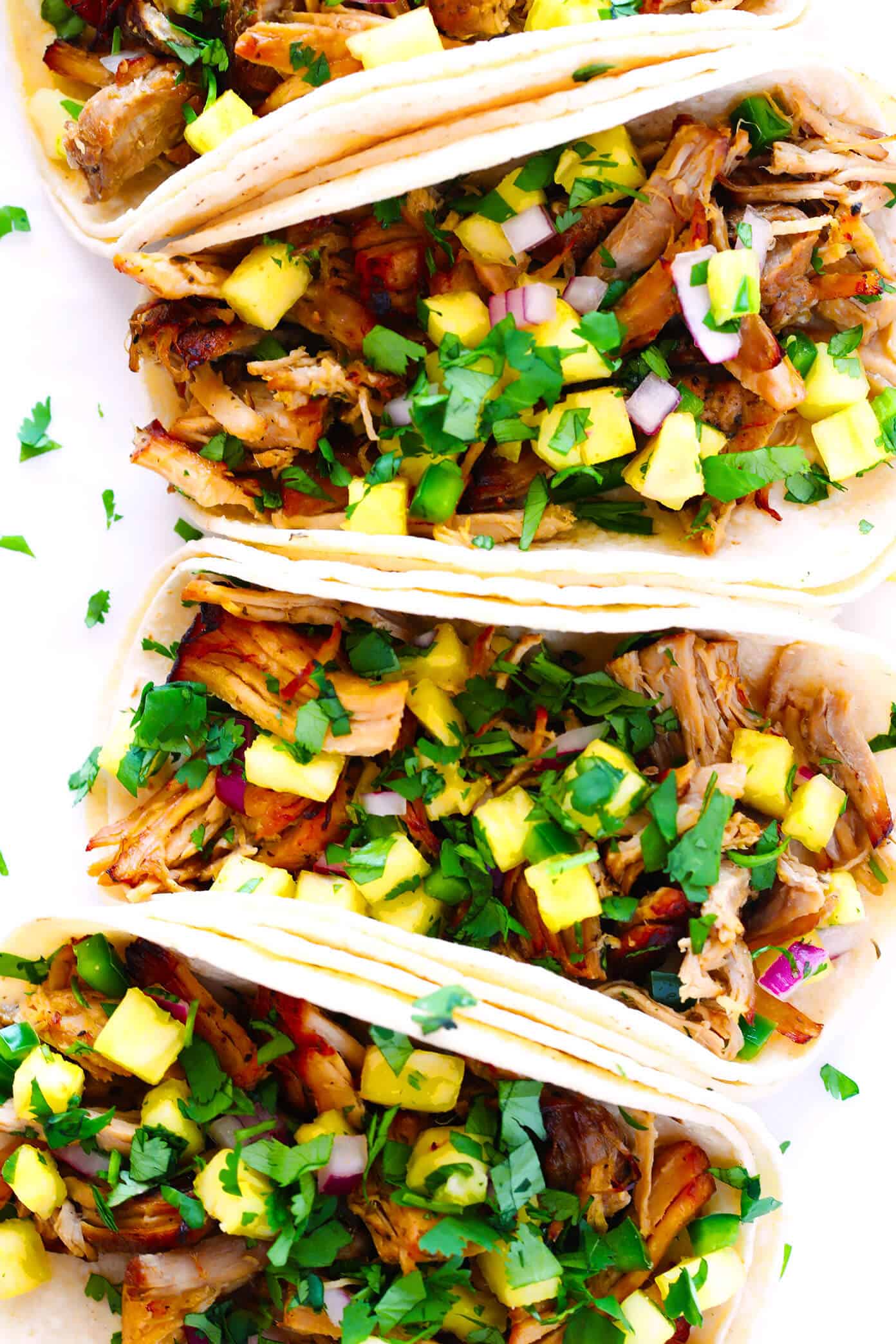 This Instant Pot Carnitas recipe is extra quick and easy to make in the pressure cooker. It's also simmered with a garlic citrus mojo sauce for extra flavor, then broiled briefly in the oven to make the pork extra crispy. Perfect for tacos, burritos, quesadillas, salads and more! | gimmesomeoven.com #carnitas #tacos #mexican #pork #dinner #instantpot #pressurecooker #mealprep Carnitas Tacos