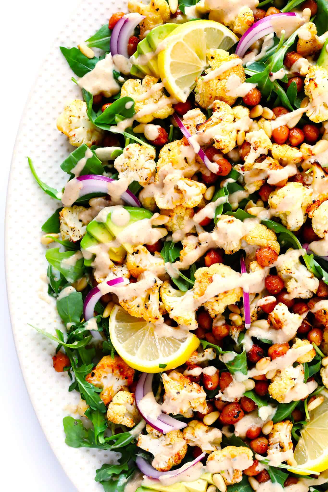The BEST Roasted Cauliflower recipe -- super easy to make in the oven, naturally #glutenfree and #vegan, and easy to customize with any of your favorite seasonings. It's the perfect healthy side dish. Or perfect for adding to a salad, soup, pizza, dip, pasta, tacos or more! | Gimme Some Oven Roasted Cauliflower, Chickpea and Arugula Salad Recipe