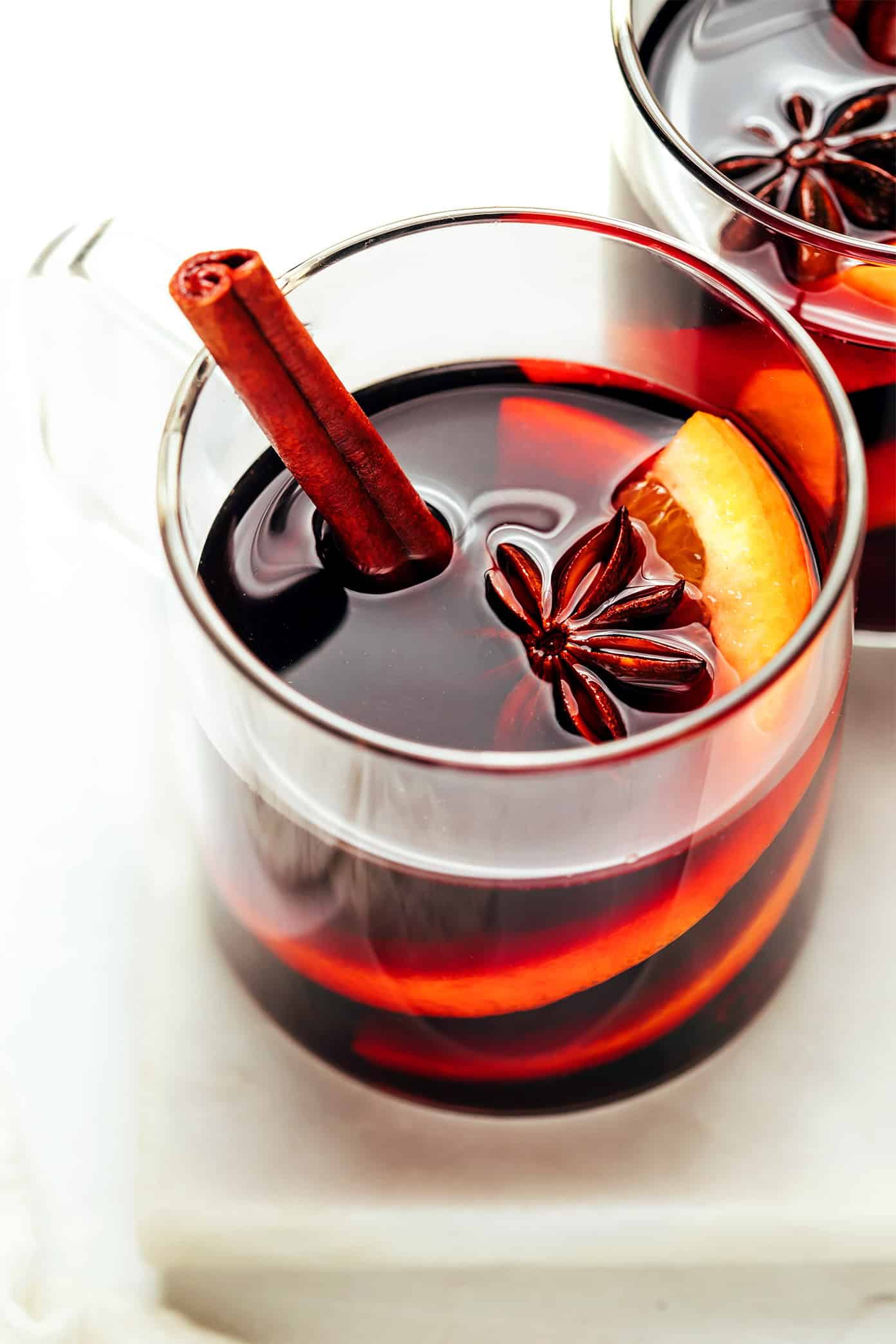 This delicious mulled wine recipe is ready to go in 20 minutes and couldn't be easier to make. Just warm a full-bodied red with brandy (or orange liqueur) and your favorite aromatics (orange, cinnamon, star anise, etc). Then the most delicious hot wine will be yours to enjoy in no time! The perfect easy drink for holiday entertaining. | gimmesomeoven.com Mulled Wine Recipe
