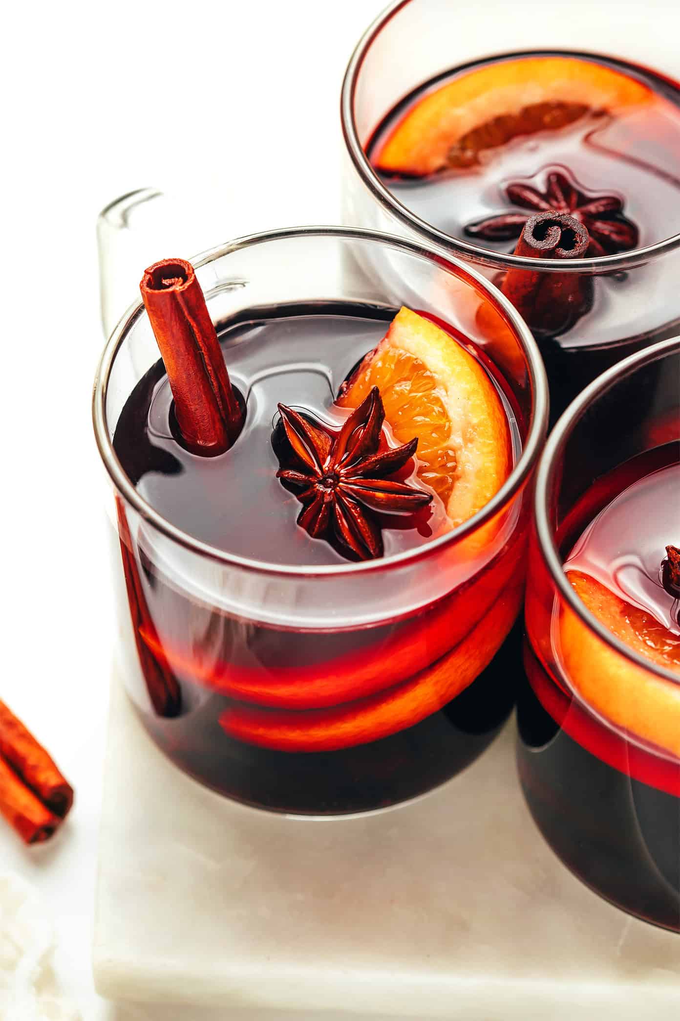 This delicious mulled wine recipe is ready to go in 20 minutes and couldn't be easier to make. Just warm a full-bodied red with brandy (or orange liqueur) and your favorite aromatics (orange, cinnamon, star anise, etc). Then the most delicious hot wine will be yours to enjoy in no time! The perfect easy drink for holiday entertaining. | gimmesomeoven.com Classic Mulled Wine Recipe
