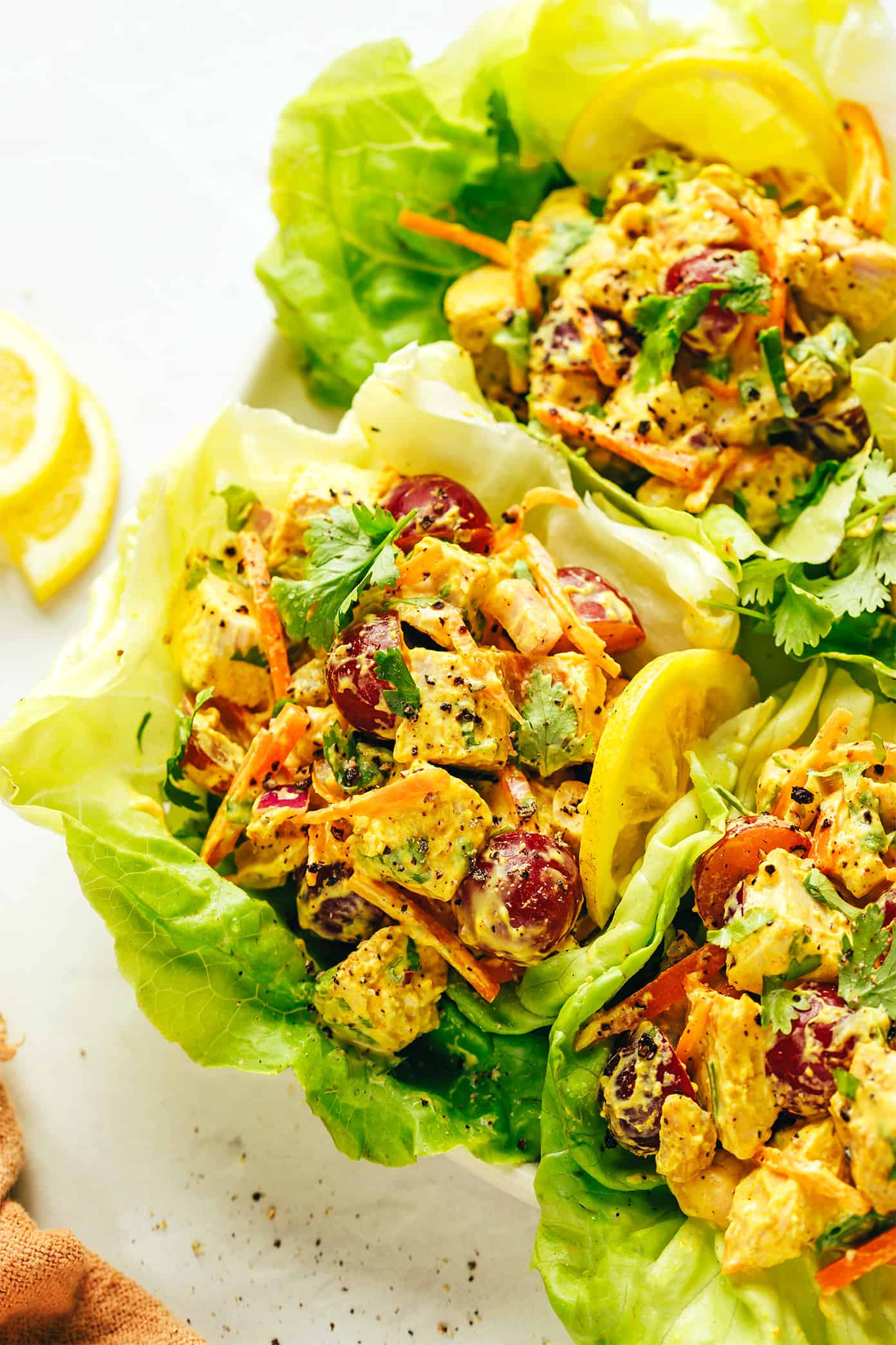 This copycat Trader Joe's curry chicken salad recipe is made with diced chicken, grapes, carrots, cashews, red onions, and a creamy Greek yogurt curry sauce. Serve in sandwiches, lettuce wraps, with crackers for dipping, or whatever sounds good! It's a high protein recipe that's perfect for meal prep and always hits the spot. | gimmesomeoven.com Curry Chicken Salad Lettuce Wraps