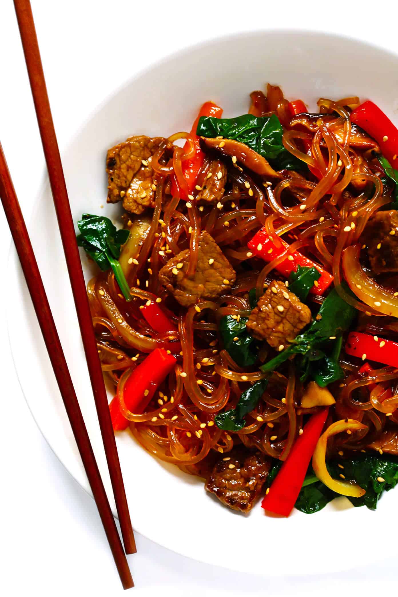 This Japchae (Korean noodle stir-fry) recipe is easy to make in just 30 minutes. It can be customized with your choice of veggies and protein (beef, chicken, shrimp, or tofu). And it is SO delicious! | gimmesomeoven.com #korean #noodle #stirfry #saute #pasta #beef #glutenfree #vegetarian #vegan #asian #dinner #mealprep #healthy Japchae Korean Noodle Stir Fry