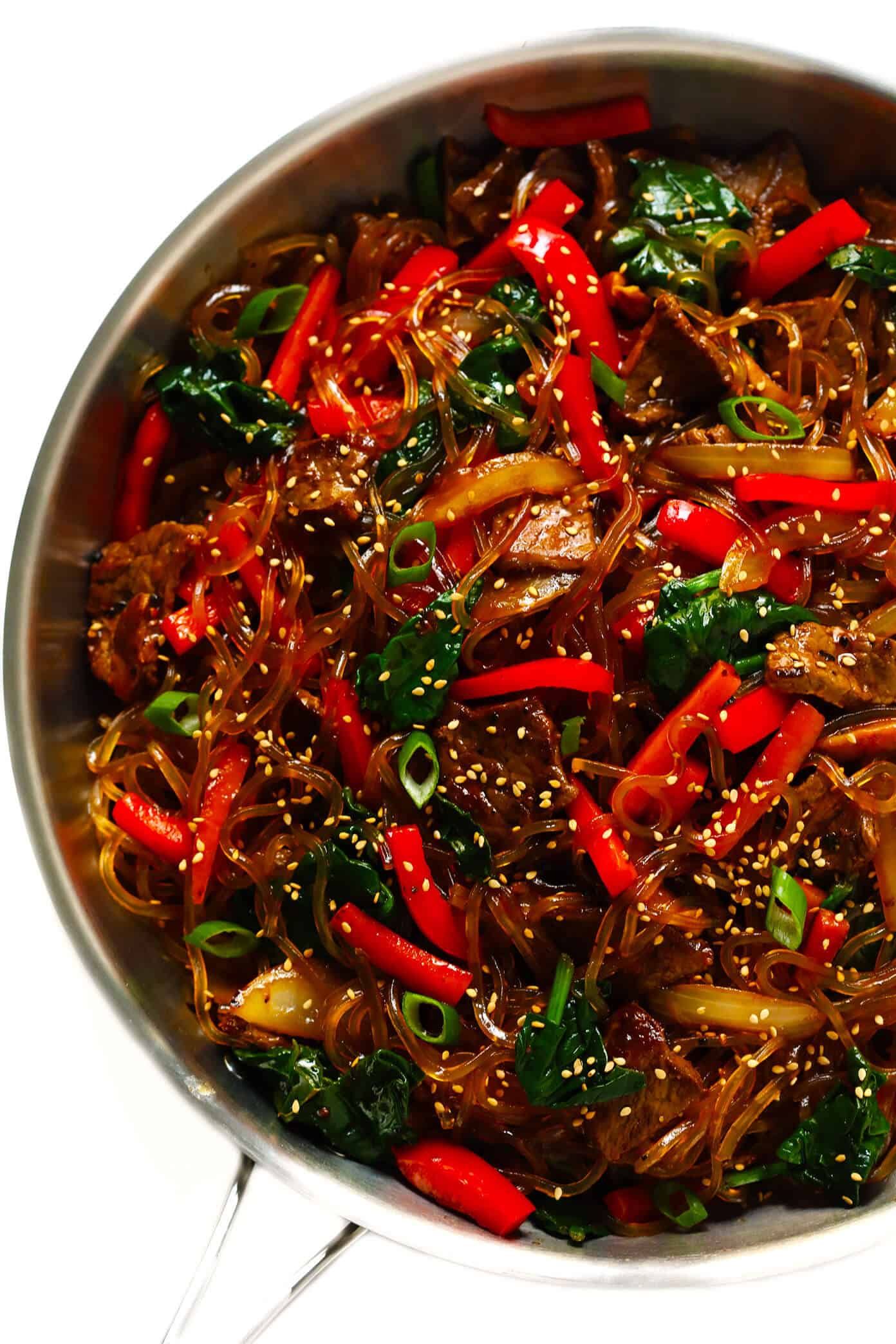 This Japchae (Korean noodle stir-fry) recipe is easy to make in just 30 minutes. It can be customized with your choice of veggies and protein (beef, chicken, shrimp, or tofu). And it is SO delicious! | gimmesomeoven.com #korean #noodle #stirfry #saute #pasta #beef #glutenfree #vegetarian #vegan #asian #dinner #mealprep #healthy How to make japchae