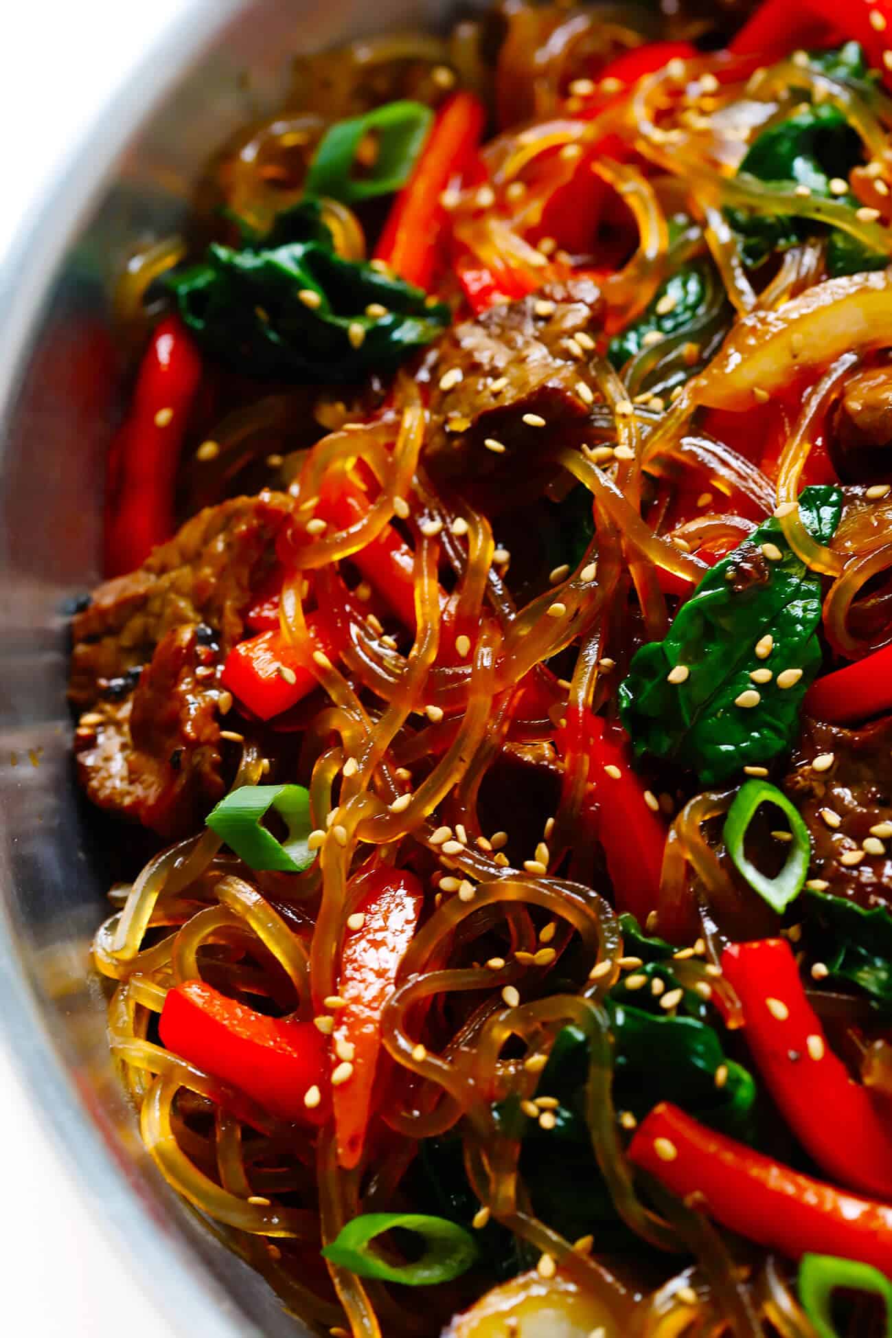 This Japchae (Korean noodle stir-fry) recipe is easy to make in just 30 minutes. It can be customized with your choice of veggies and protein (beef, chicken, shrimp, or tofu). And it is SO delicious! | gimmesomeoven.com #korean #noodle #stirfry #saute #pasta #beef #glutenfree #vegetarian #vegan #asian #dinner #mealprep #healthy Korean noodles japchae recipe
