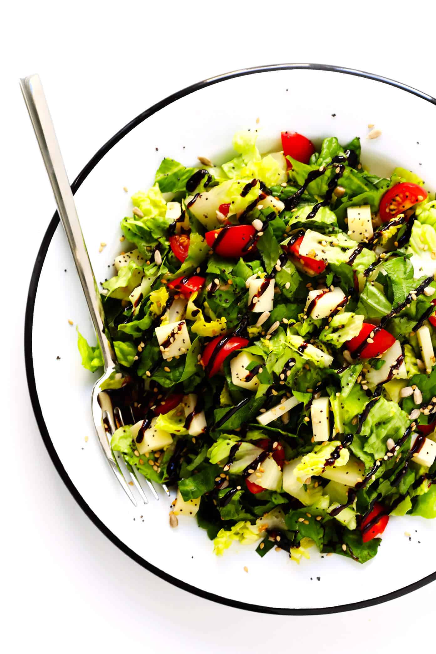 This unforgettable Italian chopped salad is made with lots of tomatoes, fresh basil, Pecorino cheese, Romaine lettuce, balsamic drizzle. And a surprise topping -- everything bagel seasoning! | Gimme Some Oven #salad #italian #choppedsalad #caprese #balsamic Unforgettable Italian Chopped Salad with Balsamic Glaze
