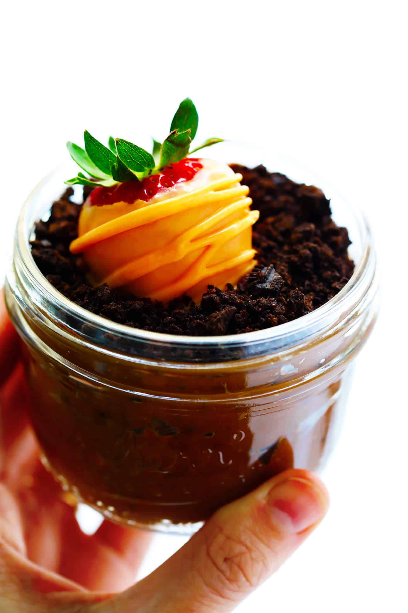 Love these Carrot Patch "Dirt" Cups! They're made with a chocolate avocado mousse pudding "dirt cake", chocolate-covered strawberry "carrots", and a sprinkling of Oreos, and they are SO delicious and fun! The perfect Spring (or Easter!) dessert that kids and adults will love alike. | Gimme Some Oven #dirtcake #easter #spring #chocolate #dessert #treats Carrot Patch "Dirt" Cakes with Chocolate-Covered Strawberries