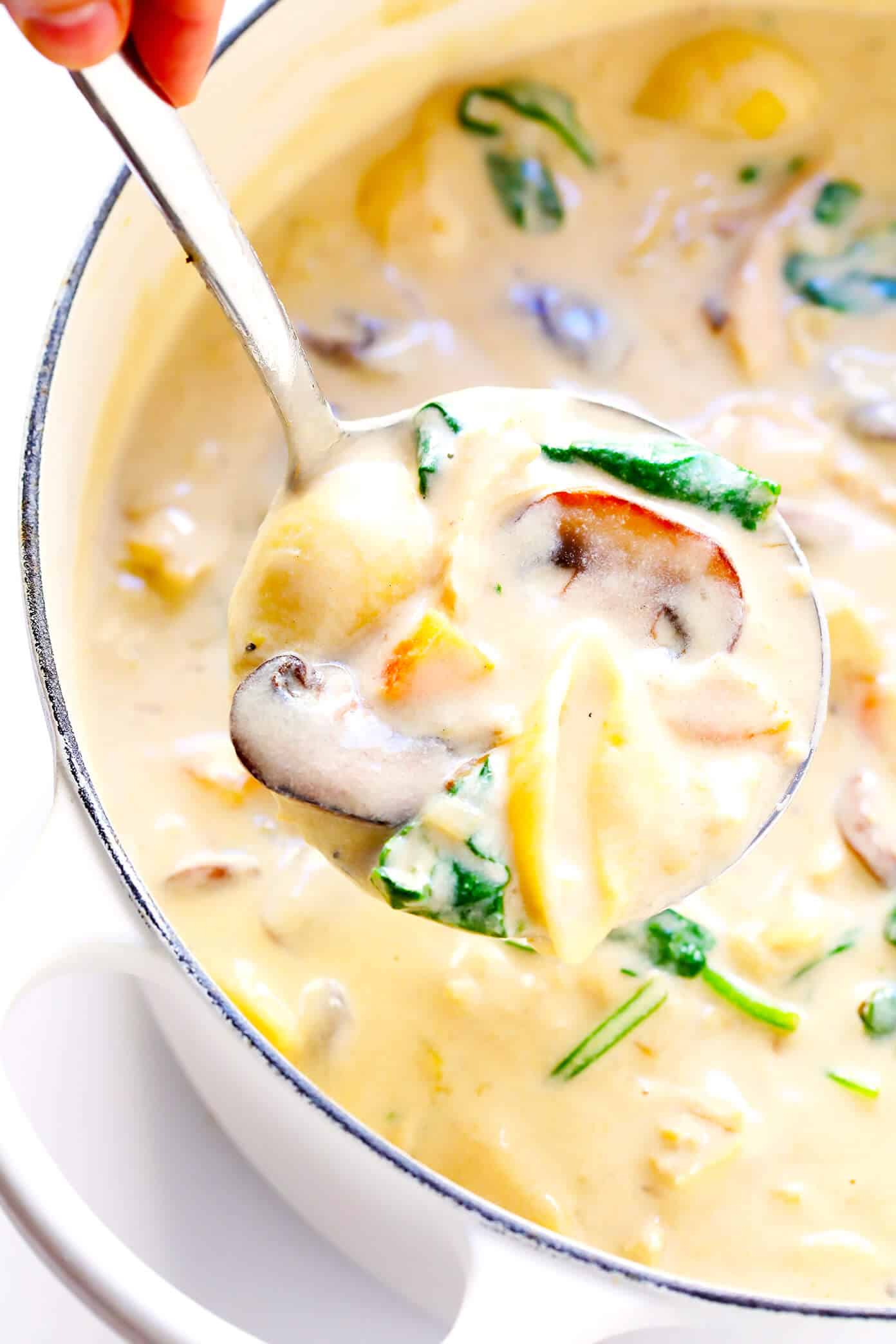 This Creamy Chicken Marsala Soup recipe is the BEST. It's made with pasta, mushrooms, carrots, and spinach...all simmered together in the most delicious creamy, garlicky, wine-infused broth. Top with Parmesan and lemon for a delicious, comforting dinner. | Gimme Some Oven #chickenmarsala #chickensoup #souprecipes #dinnerrecipes #comfortfood Creamy Chicken Marsala Soup recipe