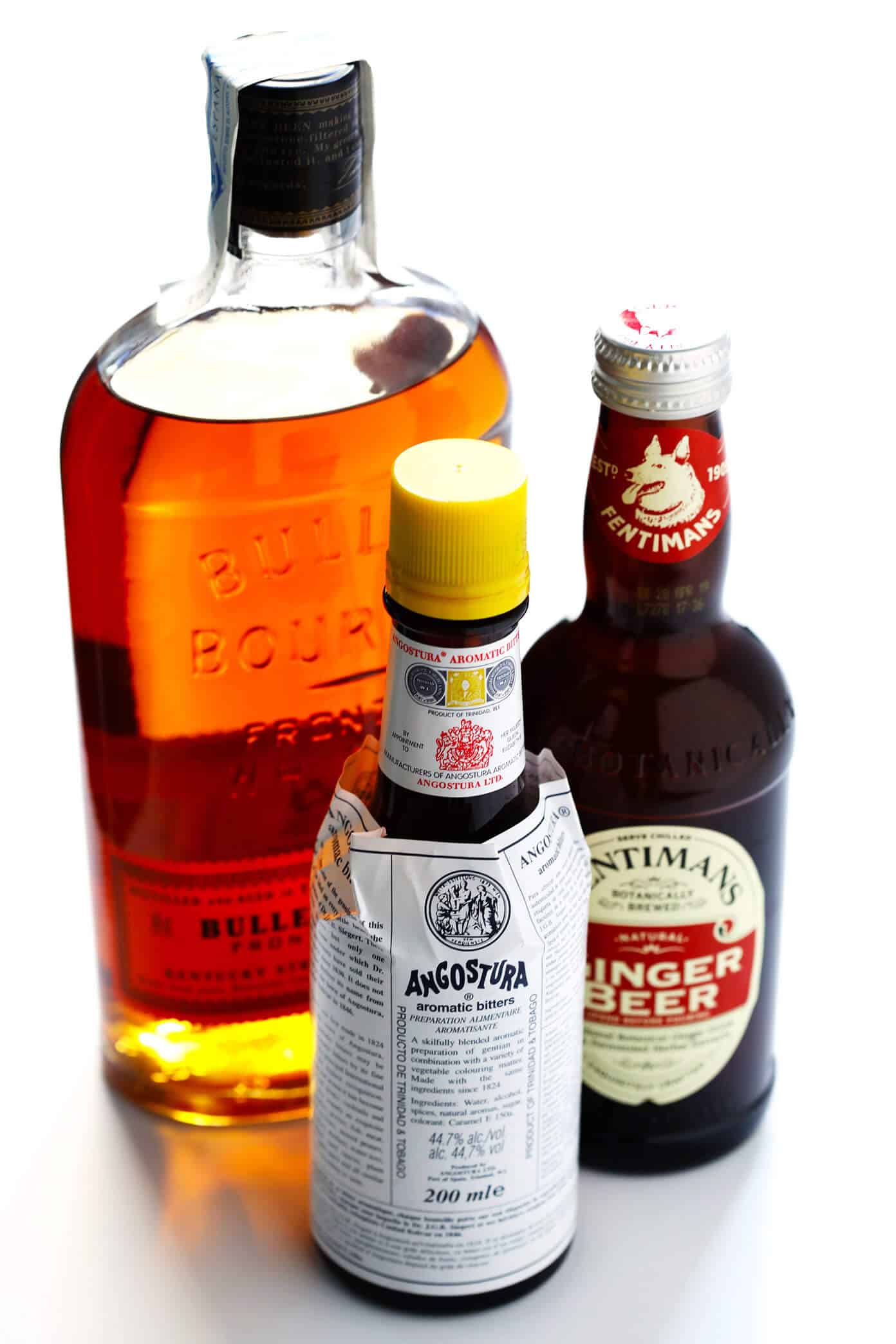 LOVE a good horsefeather cocktail! It's basically a whiskey version of a Moscow mule, made with bourbon, ginger beer, bitters and a twist of lime or lemon. Perfect for easy entertaining! | Gimme Some Oven #cocktail #whiskey #bourbon #moscowmule #gingerbeer Ingredients for a Horsefeather Cocktail: bourbon, bitters, ginger beer