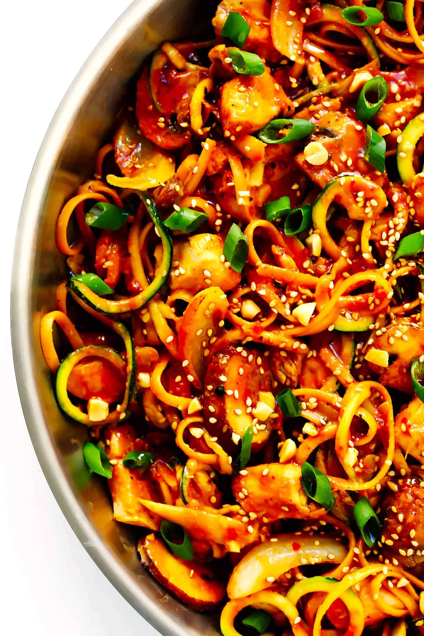 This Kung Pao Chicken Noodle Stir-Fry recipe is quick and easy to make, easy to customize with your favorite veggies (I used zoodles, mushrooms and onions) and/or proteins (shrimp, pork, beef or tofu would also work well!), and it's tossed with the most DELICIOUS zesty peanut sauce. Feel free to make it as spicy or mild as you'd like! | Gimme Some Oven #kungpaochicken #chickennoodle #stirfry #dinnerrecipes #easyrecipes Kung Pao Chicken Noodle Stir-Fry