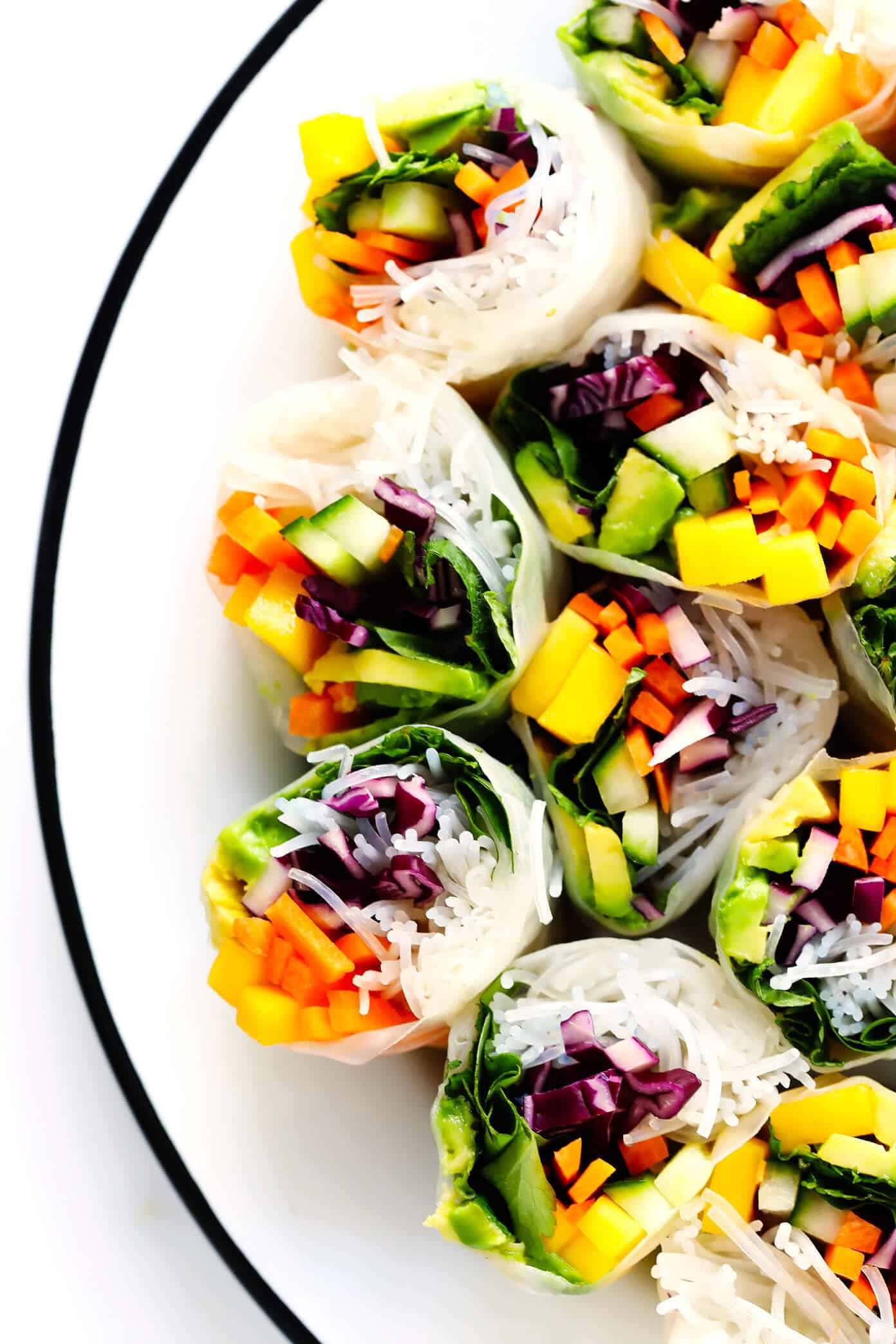 Love these Mango Avocado Spring Rolls! They're easy to make with your favorite fillings, naturally gluten-free and vegan, and served with the most irresistible peanut dipping sauce. The perfect appetizer, snack or main course! | Gimme Some Oven #springrolls #appetizer #glutenfree #vegetarian #peanutsauce Vietnamese spring roll recipe