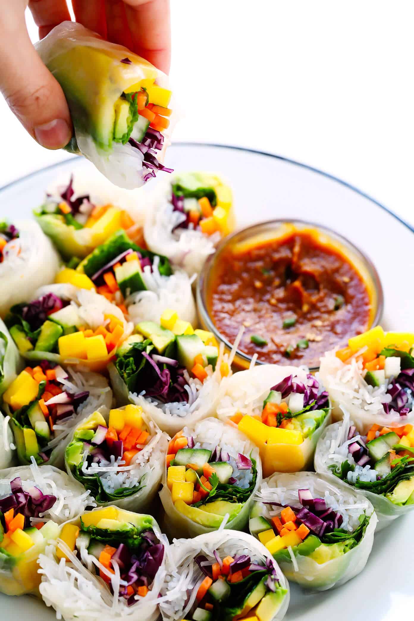Love these Mango Avocado Spring Rolls! They're easy to make with your favorite fillings, naturally gluten-free and vegan, and served with the most irresistible peanut dipping sauce. The perfect appetizer, snack or main course! | Gimme Some Oven #springrolls #appetizer #glutenfree #vegetarian #peanutsauce How to make Vietnamese spring rolls, plus an easy peanut dipping sauce recipe