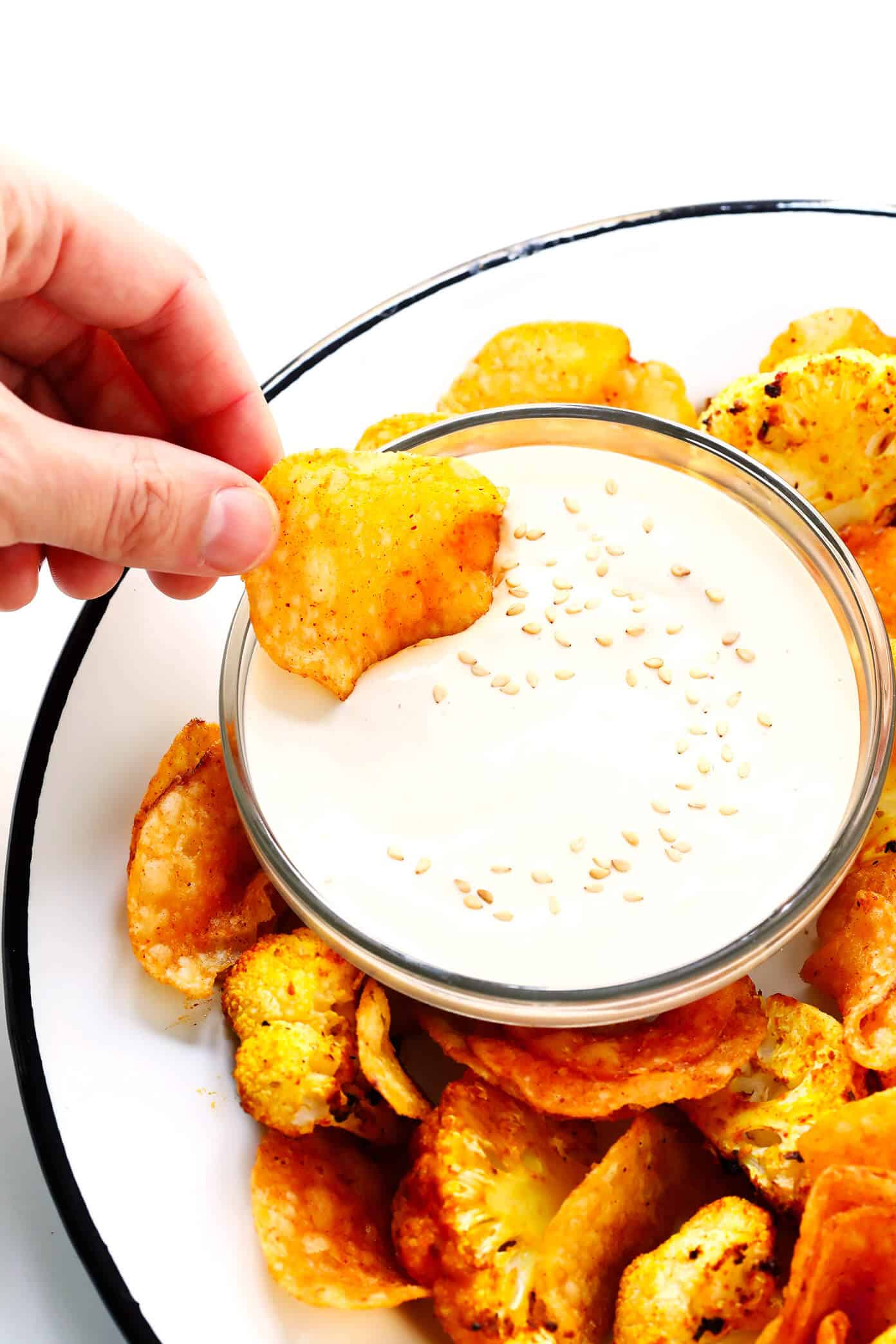 This 5-Minute Dreamy Tahini Dip recipe is quick and easy to make in the blender, it's naturally gluten-free and vegan, and it goes with just about everything. The perfect healthy appetizer or snack! | Gimme Some Oven #tahini #dip #appetizer #vegan #glutenfree 5-Minute Dreamy Tahini Dip with Roasted Cauliflower and Kettle Chips