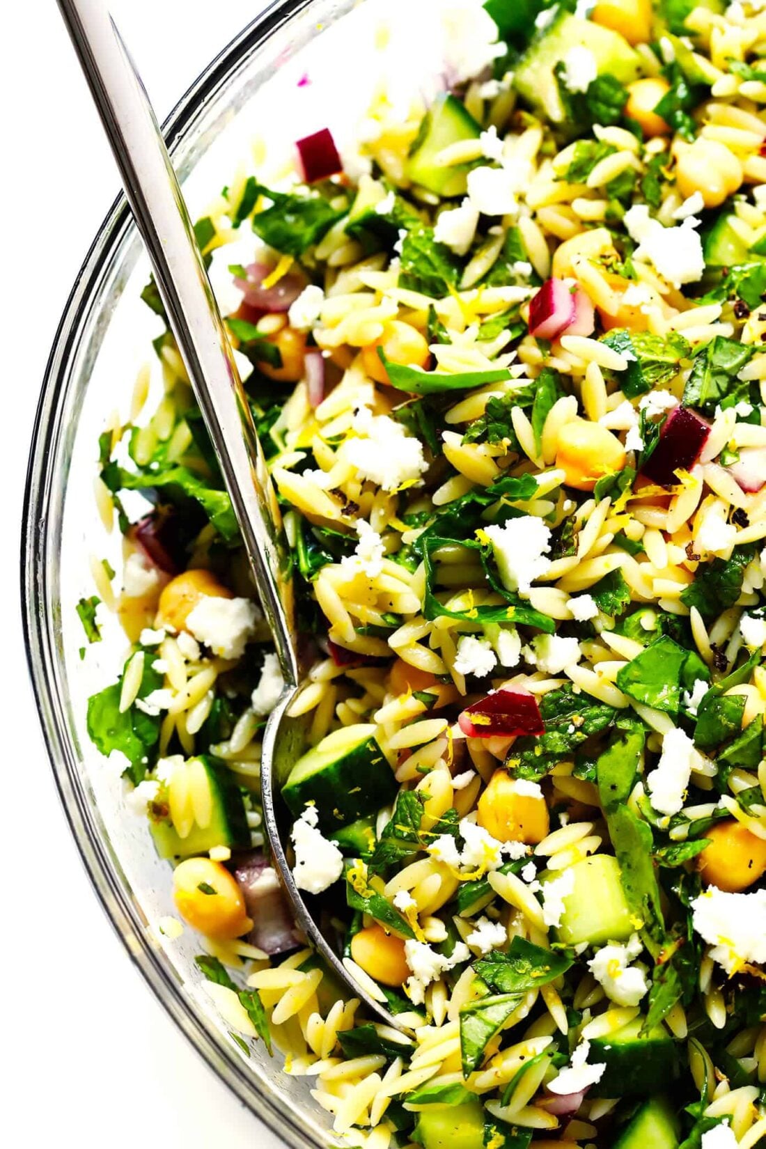 This Lemony Orzo Pasta Salad is made with hearty orzo pasta, fresh spinach or arugula, chickpeas, cucumber, onions, feta cheese, and a lemon herb dressing. It's the perfect make ahead pasta salad for summer! | gimmesomeoven.com #pastasalad #vegetarian #dinner #mealprep #dressing #pasta Herb Lovers Lemon Orzo Salad