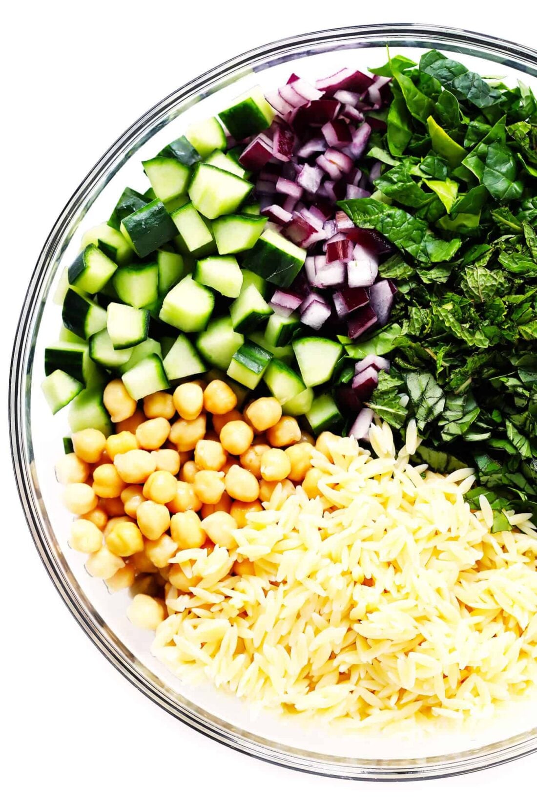 This Lemony Orzo Pasta Salad is made with hearty orzo pasta, fresh spinach or arugula, chickpeas, cucumber, onions, feta cheese, and a lemon herb dressing. It's the perfect make ahead pasta salad for summer! | gimmesomeoven.com #pastasalad #vegetarian #dinner #mealprep #dressing #pasta Lemon Orzo Pasta Salad Ingredients