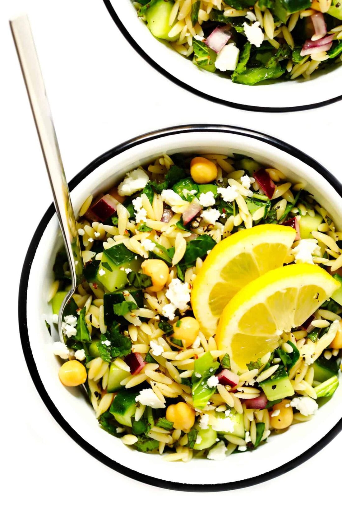 This Lemony Orzo Pasta Salad is made with hearty orzo pasta, fresh spinach or arugula, chickpeas, cucumber, onions, feta cheese, and a lemon herb dressing. It's the perfect make ahead pasta salad for summer! | gimmesomeoven.com #pastasalad #vegetarian #dinner #mealprep #dressing #pasta Herb Lovers Lemon Orzo Pasta Salad